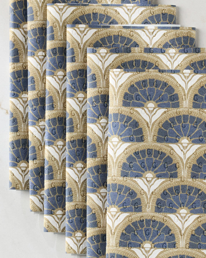 Five Eliza napkins by Amy MacCready, featuring blue and gold art deco fan patterns, are displayed on a white surface—an eco-friendly alternative to disposable paper towels.