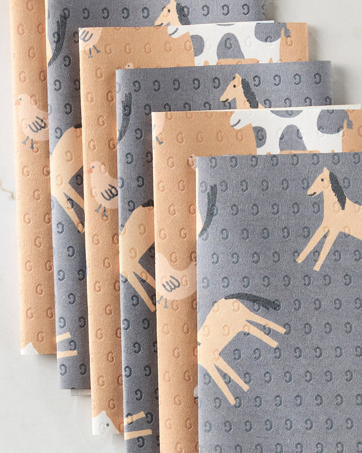 Six folded reusable paper towels from Coit Creative’s Farm Animals set are arranged side by side, each with playful horse illustrations—an eco-friendly home alternative.