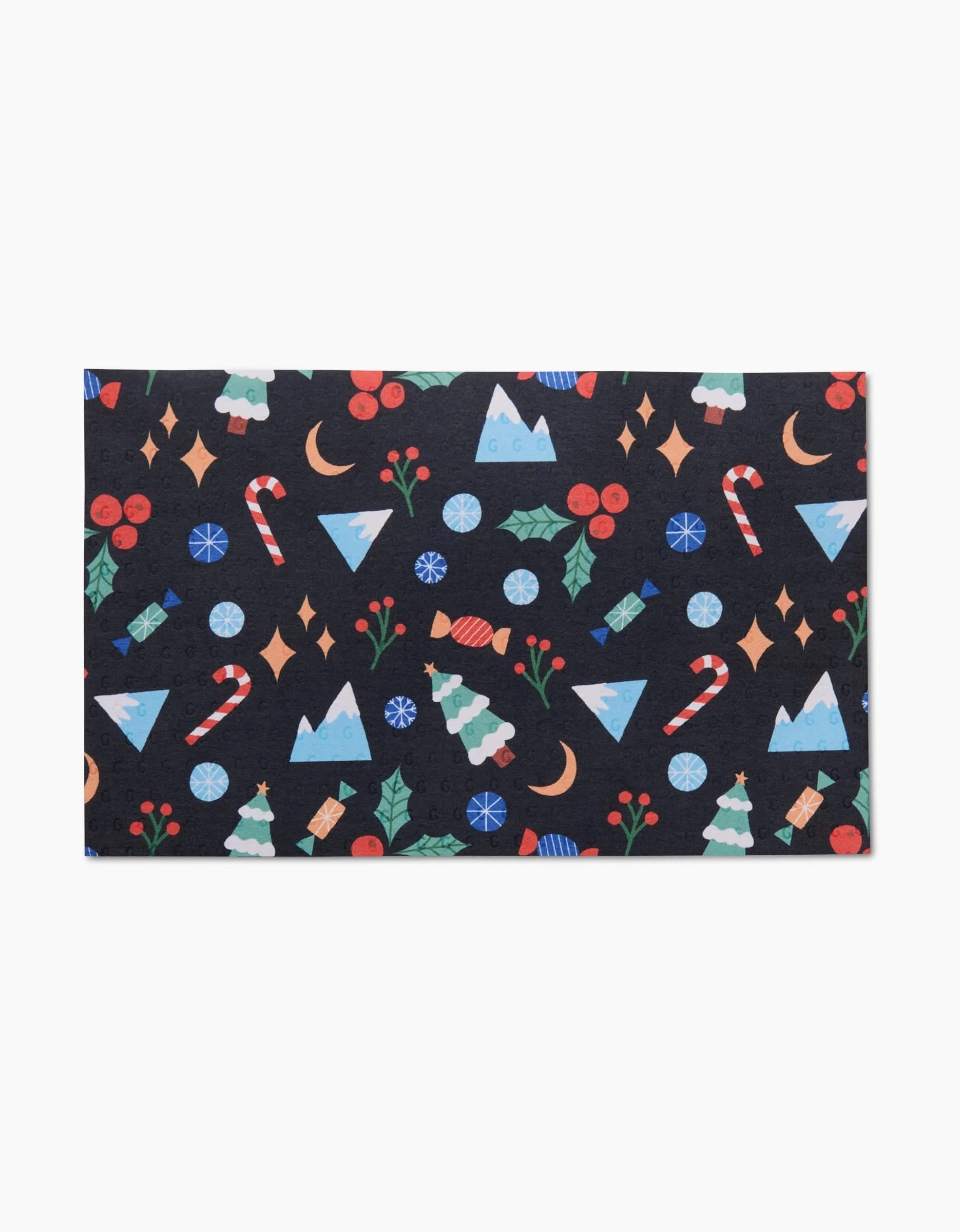 The Claire Iglesias Festive Christmas mat is a rectangular, machine-washable, eco-friendly décor featuring cheerful Christmas trees, holly, candy canes, berries, blue triangles, moons, and stars.