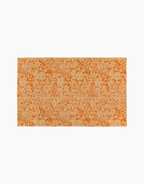 The Florence rug by Katie OShea is a rectangular orange piece with beige floral and leafy patterns on a plain white background, adding eco-friendly style and sustainability to any space.