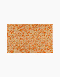 The Florence rug by Katie OShea is a rectangular orange piece with beige floral and leafy patterns on a plain white background, adding eco-friendly style and sustainability to any space.