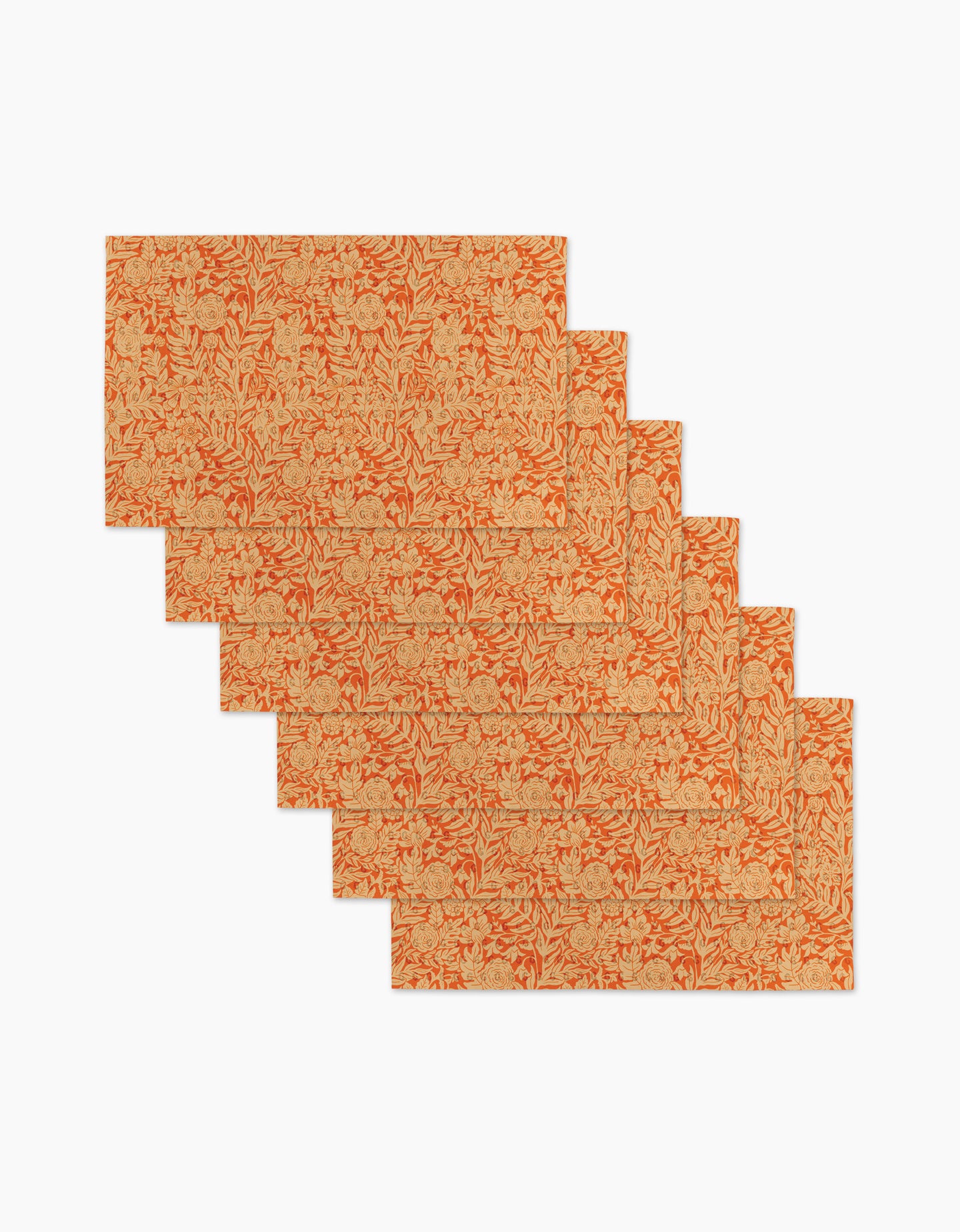 Six Florence rectangular placemats by Katie OShea, featuring an orange and beige floral pattern, are stylishly arranged in a staggered, overlapping layout on a white background.