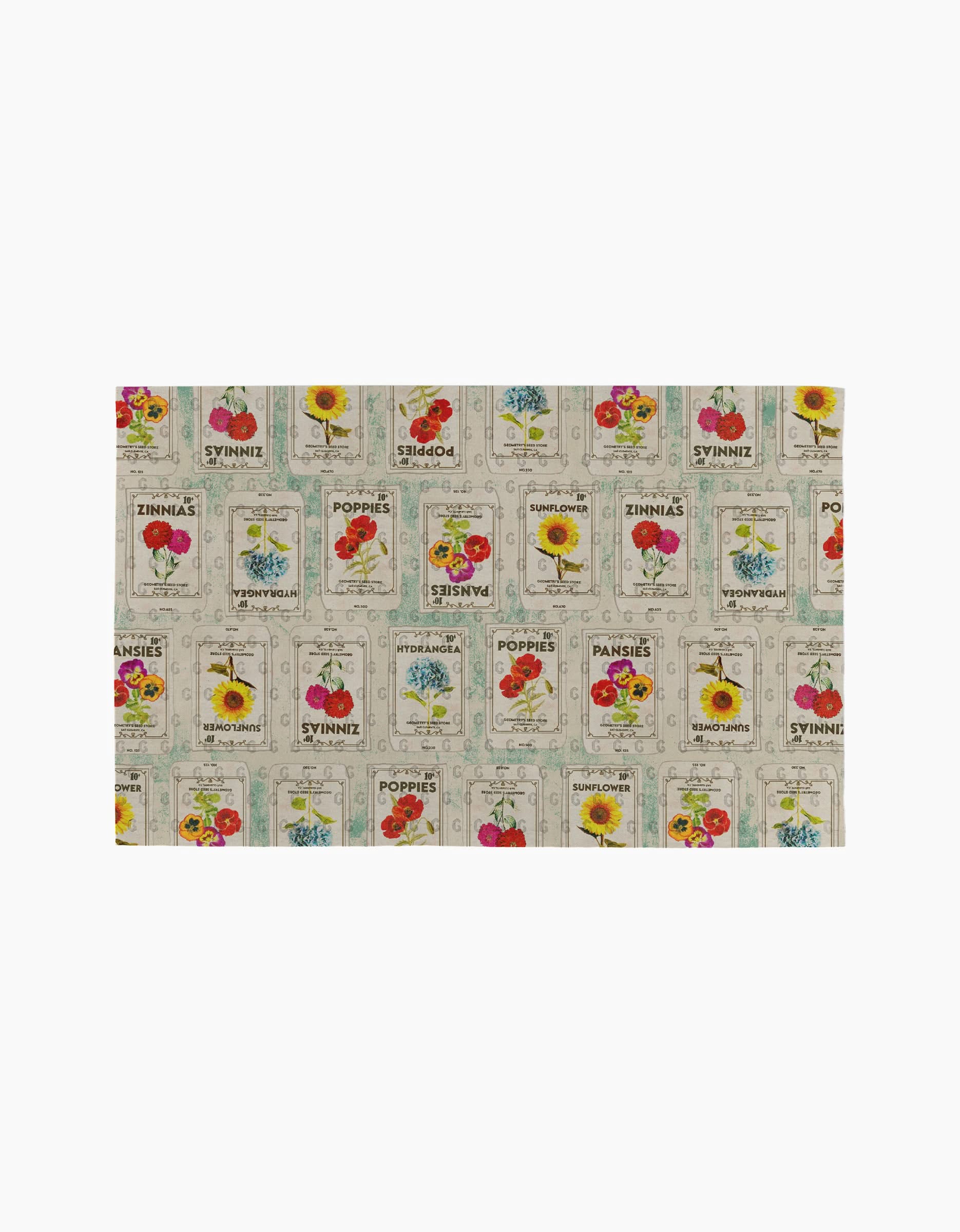Geometrys Flower Seed Packs cloth features a vibrant vintage-style pattern with seed packet illustrations of flowers like poppies, zinnias, pansies, and sunflowers on a light background—an eco-friendly alternative to paper towels.