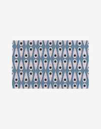 Forest Findings by Anette Heiberg features a repeating geometric pattern of blue X-shapes with white tear-drop centers and black dots on a light background—an eco-friendly alternative to Not Paper Towels.