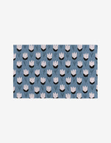 Forest Findings by Anette Heiberg is a rectangular fabric featuring stylized light pink tulips and dark green stems on a muted blue background—a sustainable, eco-friendly option thats not paper towels. Perfect for greener living.