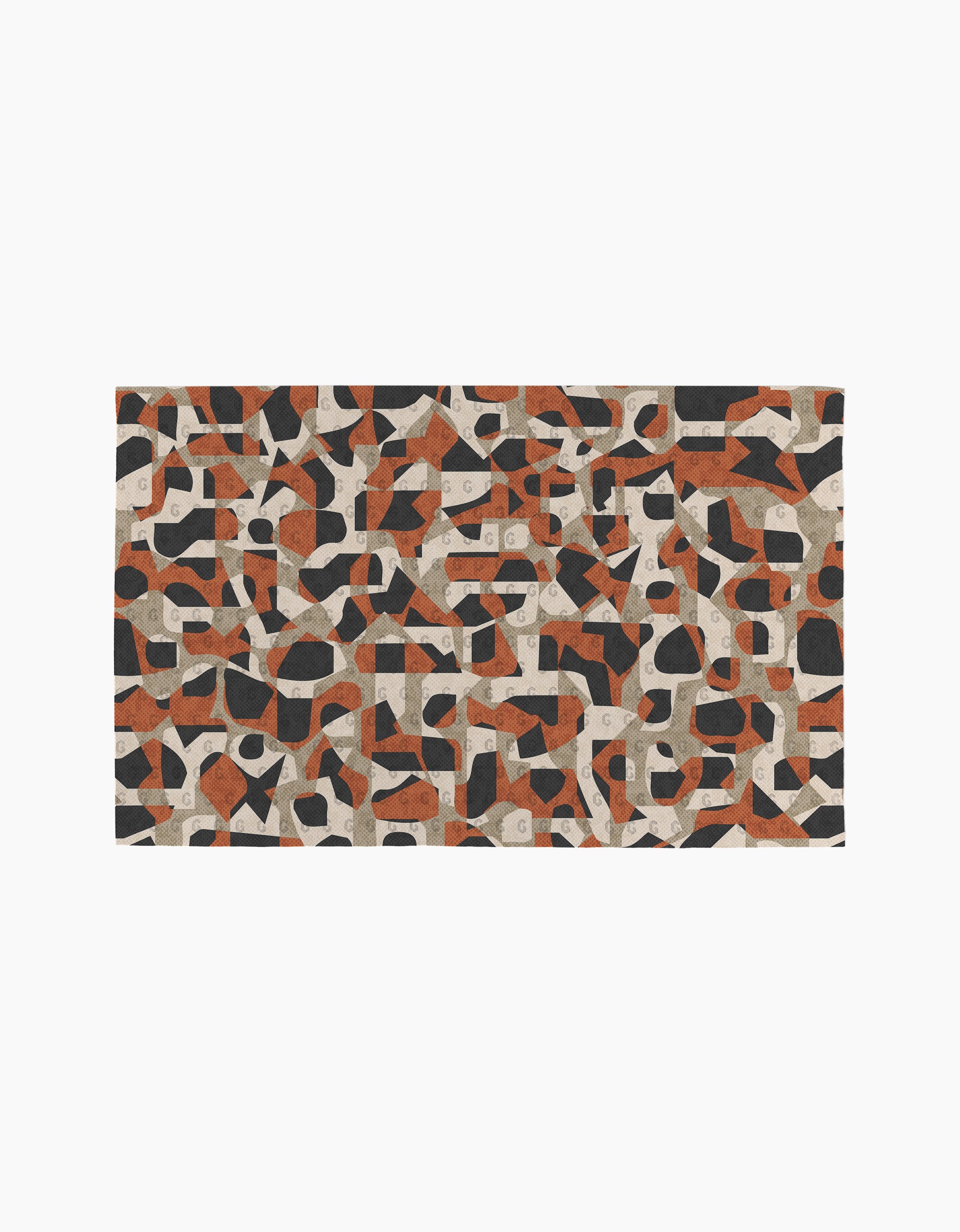 The Geometric Leopard rug by Kris Ruff features an abstract geometric pattern in black, reddish-brown, gray, and beige on white. Its modern design pairs perfectly with eco-friendly paper towels for a thoughtfully styled space.