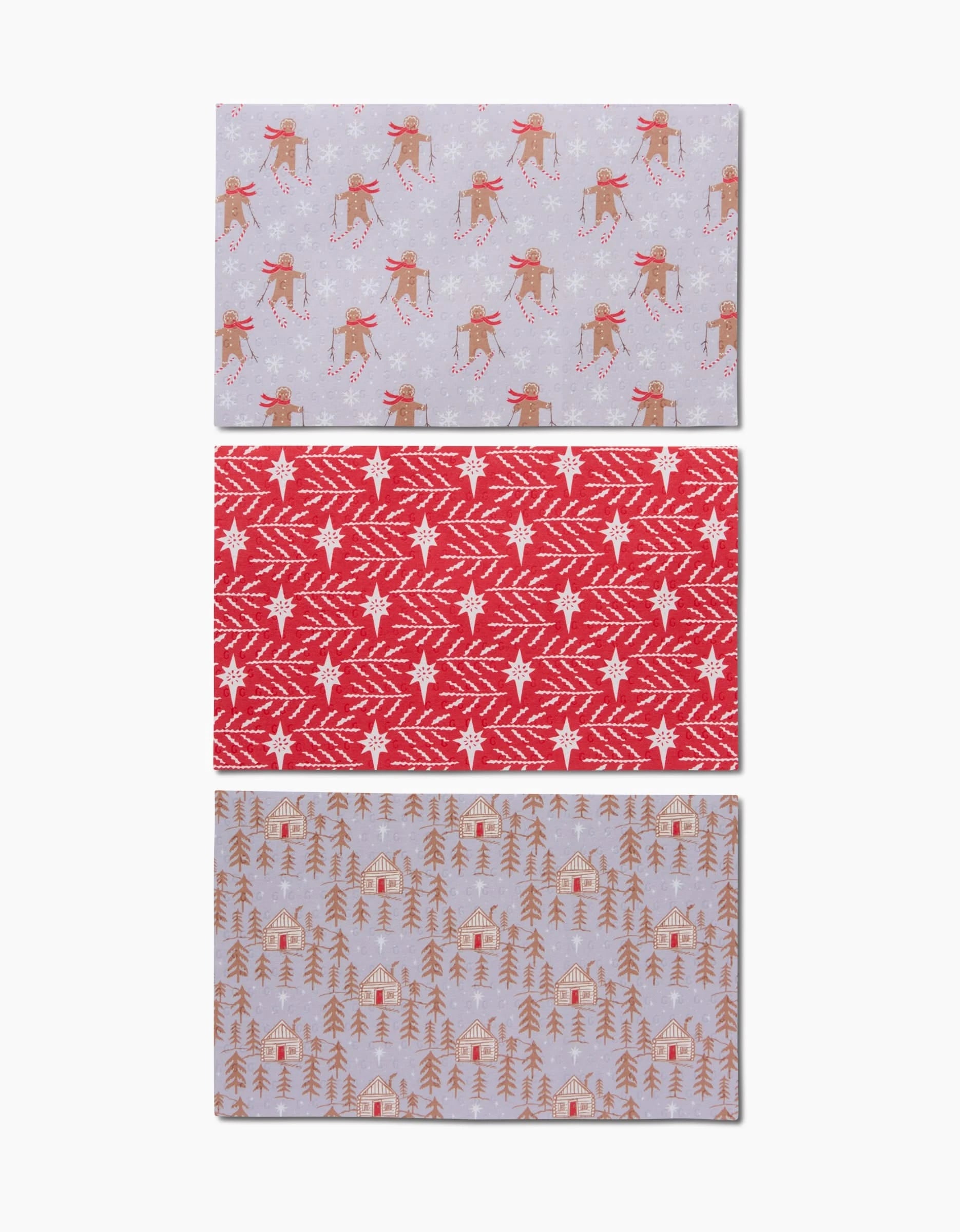 Three reusable rectangular Gingerbread Land sheets by Roxy Marj for an eco-friendly holiday: top features skiing reindeer, middle has red & white snowflakes/branches, bottom shows cabins, trees & reindeer.