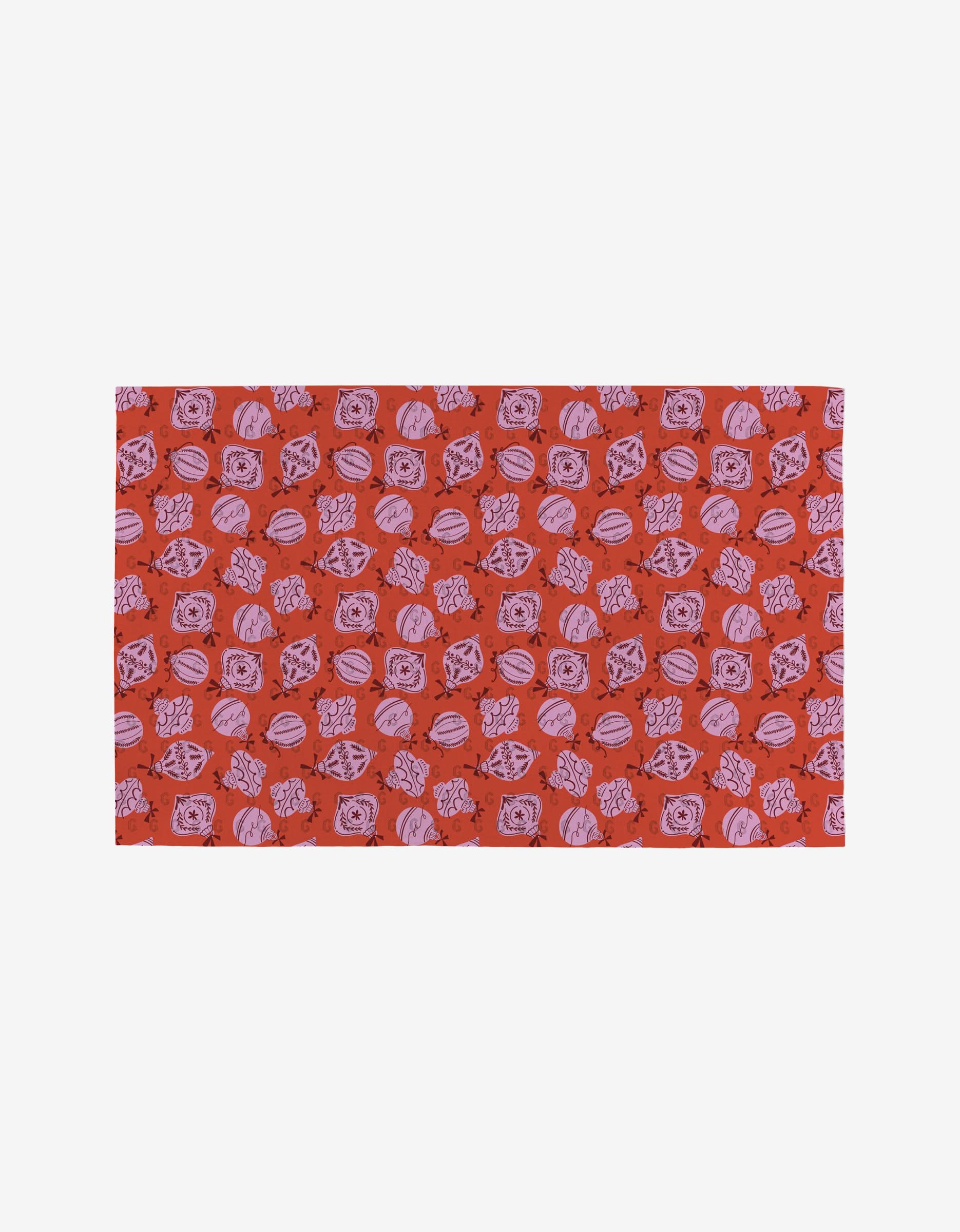 The Grams Ornaments by Charlie Rowan Designs is a rectangular fabric with a red background and repeating pink and purple seashells. Made from post-consumer recycled materials, its both stylish and eco-friendly.