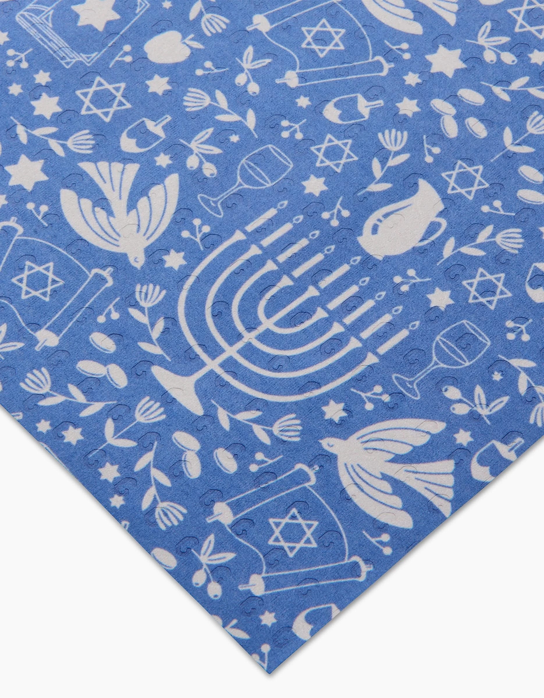 Hanukkah Sameach by Megan Kampa features blue fabric with white Hanukkah-themed illustrations, including menorahs and dreidels; machine washable and perfect as an eco-friendly, reusable paper towel alternative.