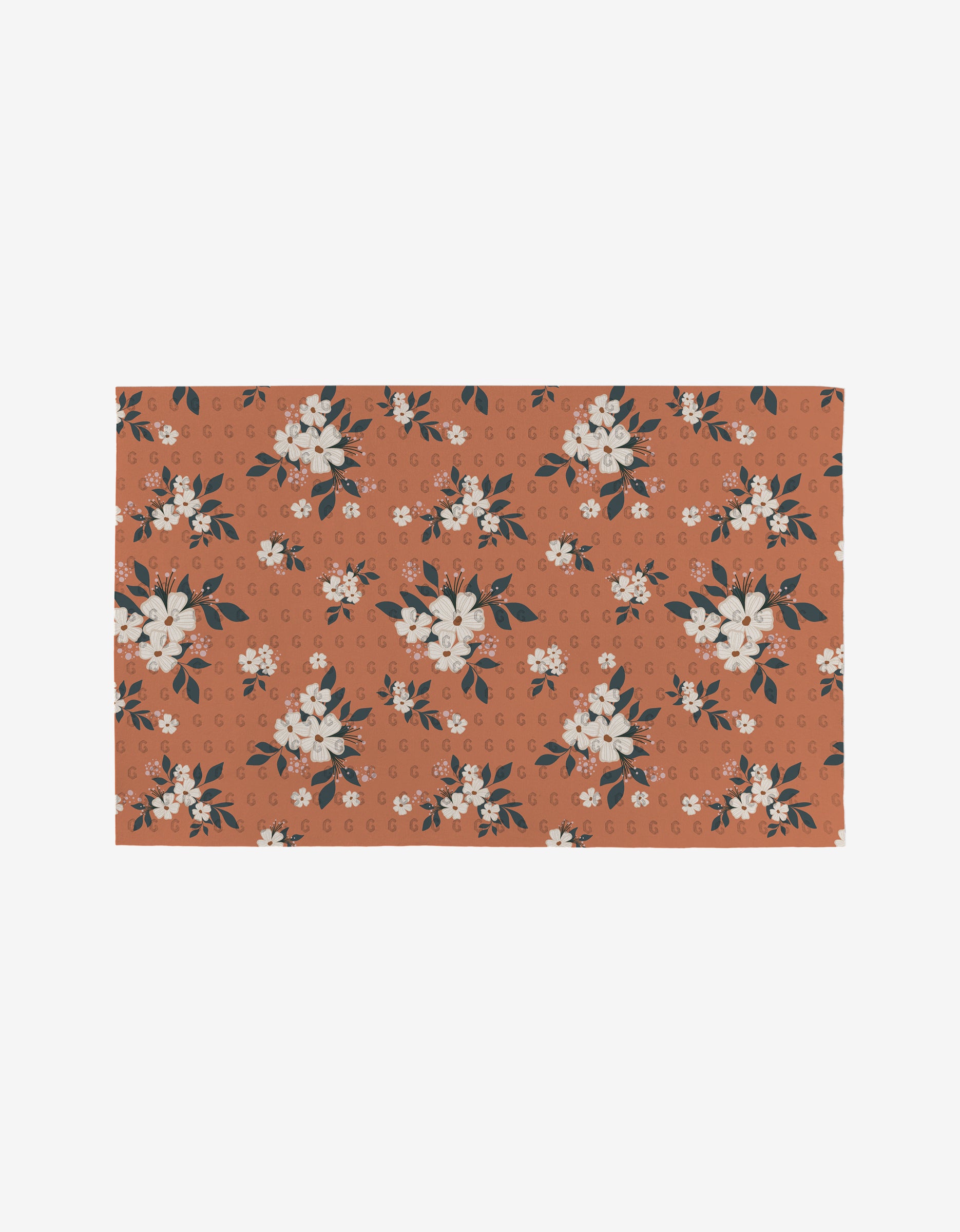 The Harvest Season mat by Charlie Rowan Designs features a rust-orange background with white flowers, dark green leaves, and light orange accents—a reusable, eco-friendly alternative to Not Paper Towels.