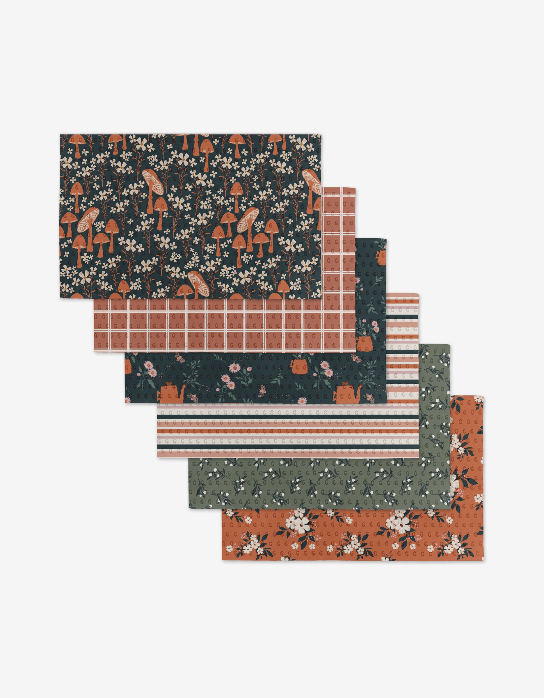 Harvest Season by Charlie Rowan Designs includes six reusable rectangular sheets, each with unique autumn patterns—mushrooms, flowers, plaid, stripes, and leaves—in earthy black, orange, green, and white. Stylish and eco-friendly.