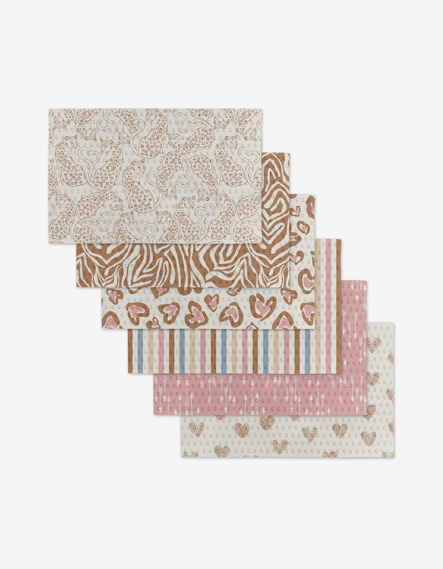 Five Heartbreaker rectangular placemats from Hufton Studio in assorted patterns and colors—brown, beige, pink, and blue—are fanned out, offering an eco-friendly alternative to Not Paper Towels.