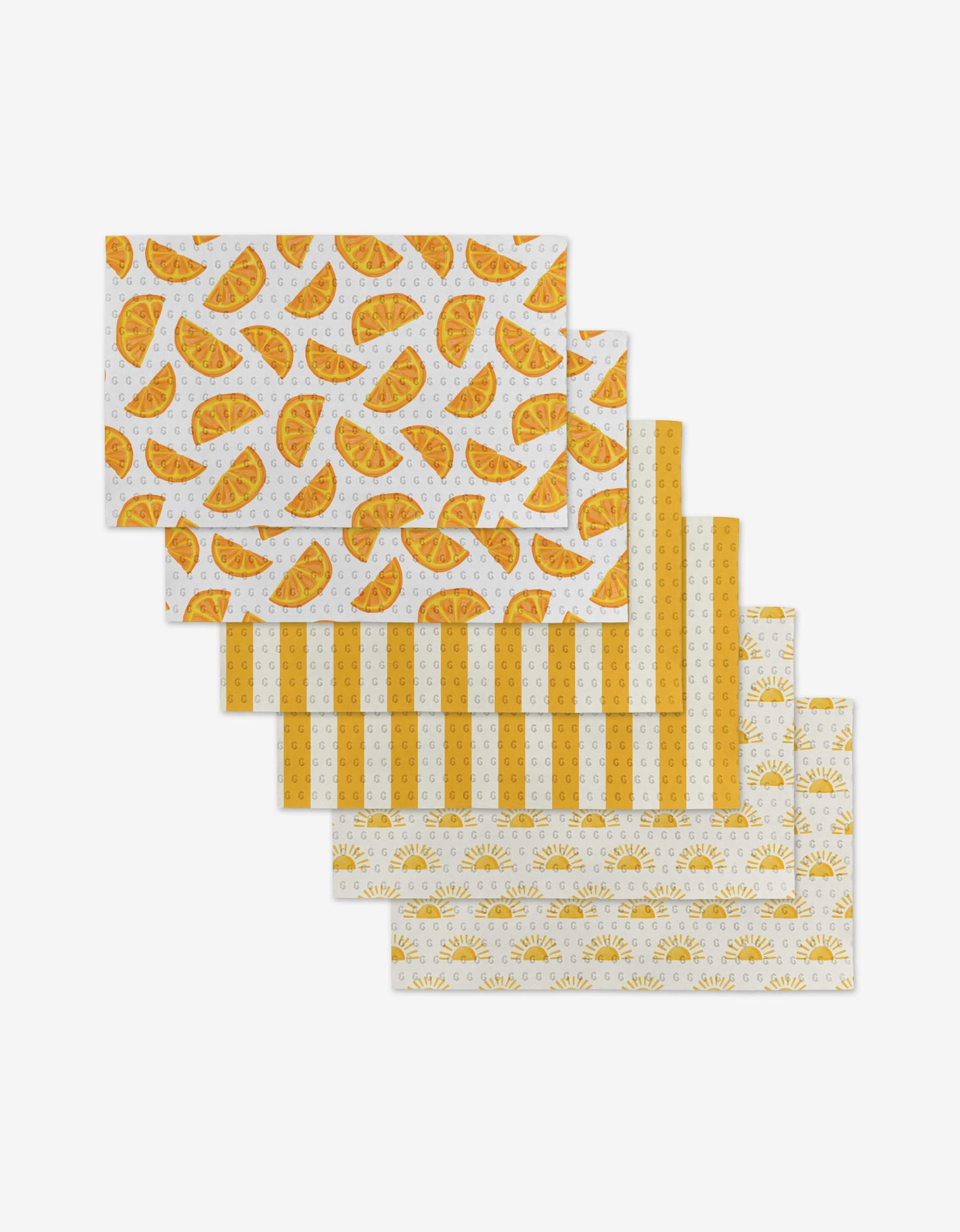 Six rectangular, eco-friendly “Here Comes The Sun” Not Paper Towels by Aubrey Fairchild, featuring yellow and orange taco, stripe, and sun patterns, arranged in a cascading stack on a white background.