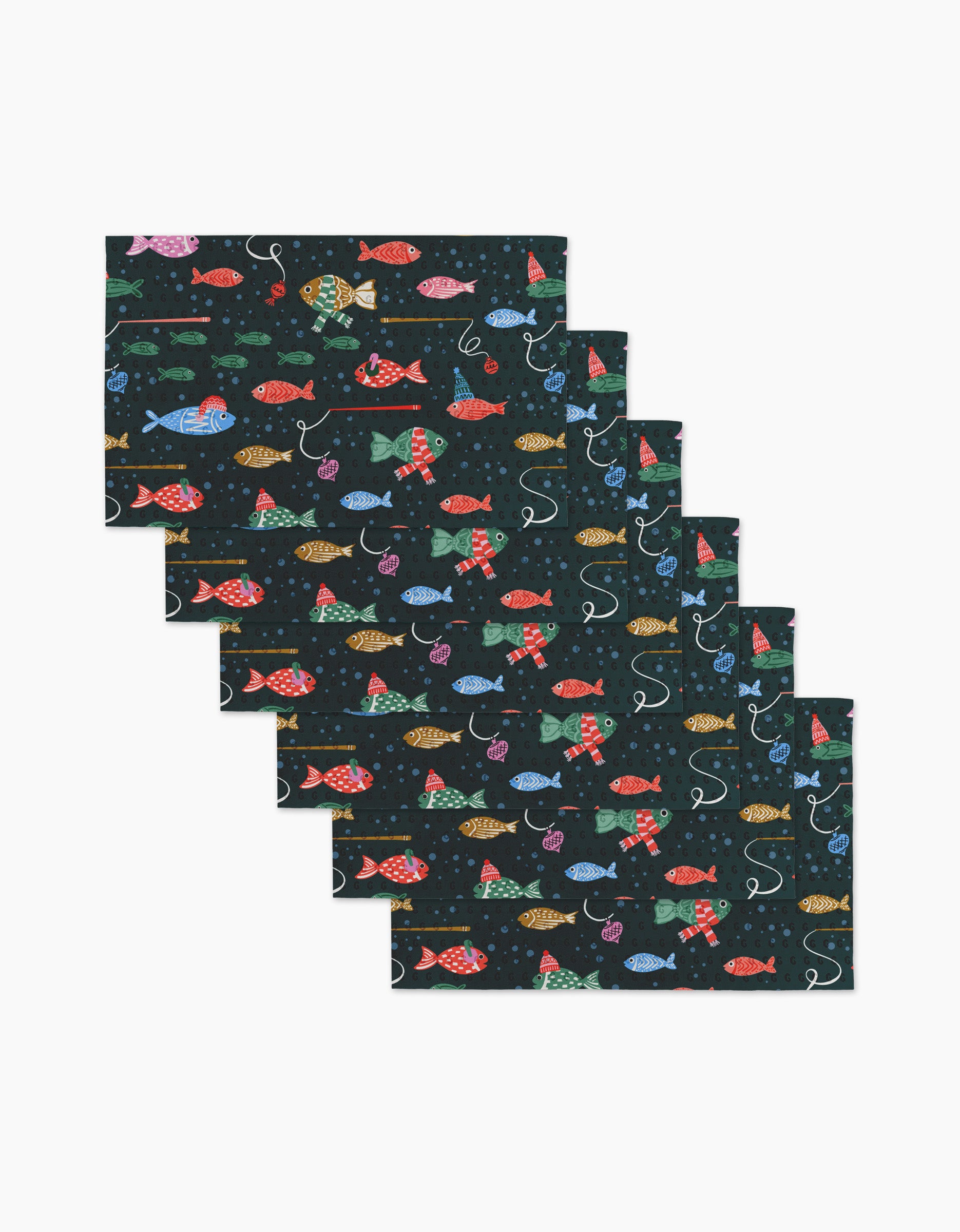 Six Holiday Fish placemats by Charlie Rowan Designs showcase a colorful fish pattern on a dark background—red, blue, yellow, and green fish with lines and hooks—crafted to pair with your reusable paper towels for an eco-friendly kitchen.