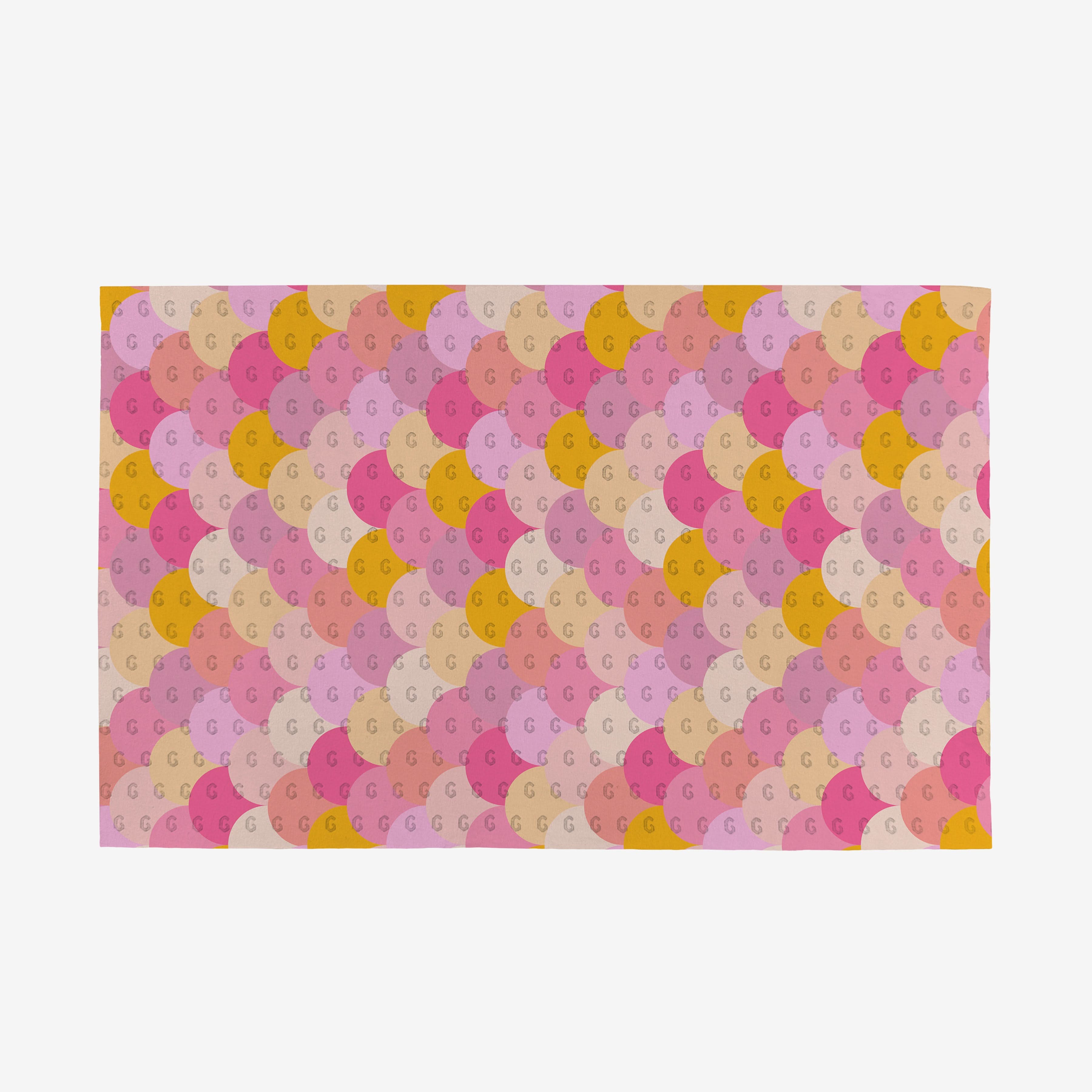 The GEOMETRY Inherit Not Paper Towel features a repeating scallop pattern in pink, peach, yellow, and tan shades. Made from eco-friendly post-consumer recycled materials, each scallop playfully displays a small G at its center.