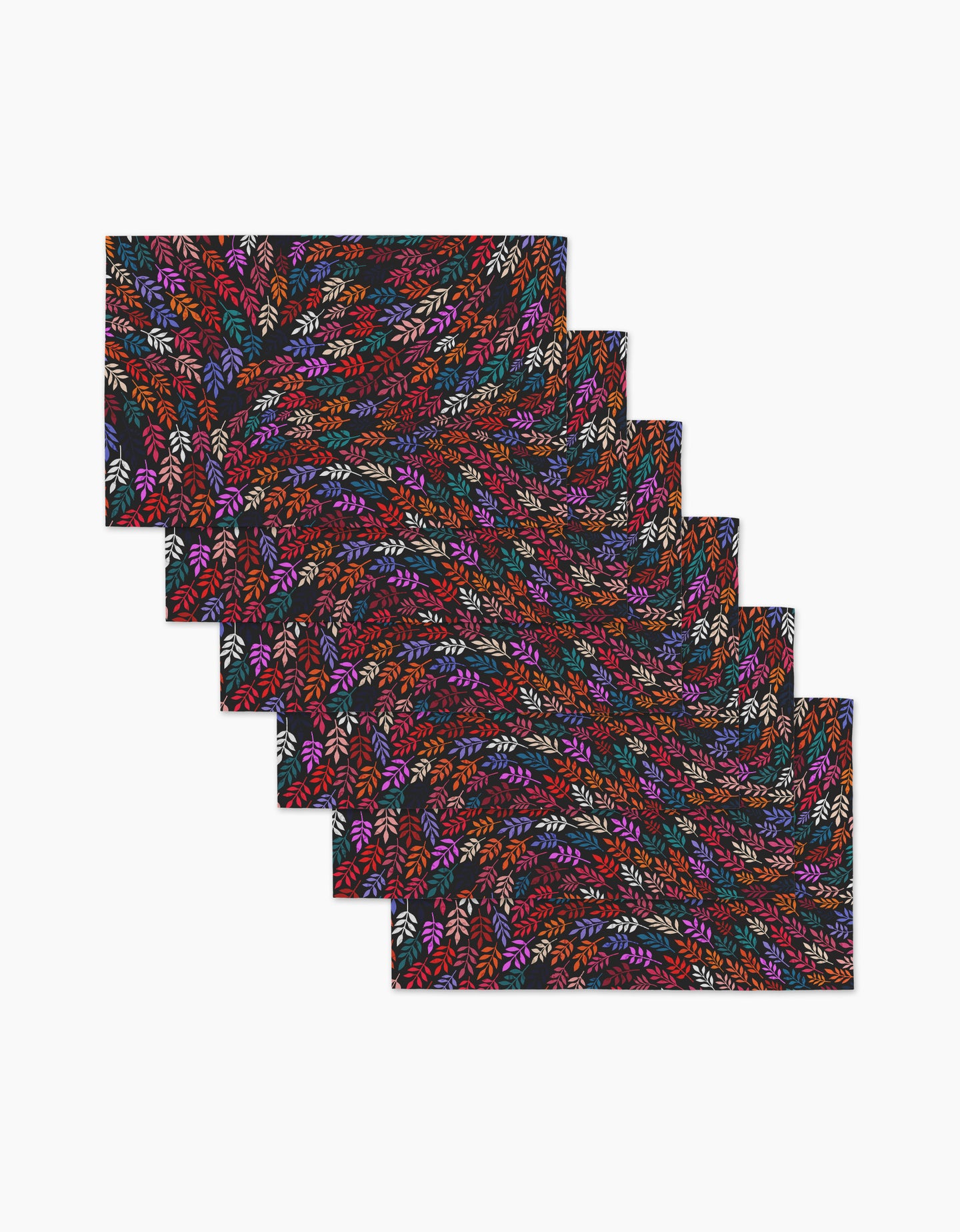 The Jewel Leaf Swirl placemat set by Rachel Parker includes six rectangular mats with a colorful leaf-like pattern in red, orange, purple, blue, and white on a dark background, arranged in an overlapping layout on a white surface.
