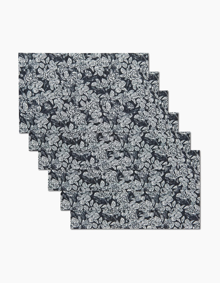 Six Love and Roses Onyx reusable paper towels by Charlie Rowan Designs, each dark-colored with a white floral pattern, are neatly stacked and slightly offset on a plain white background.