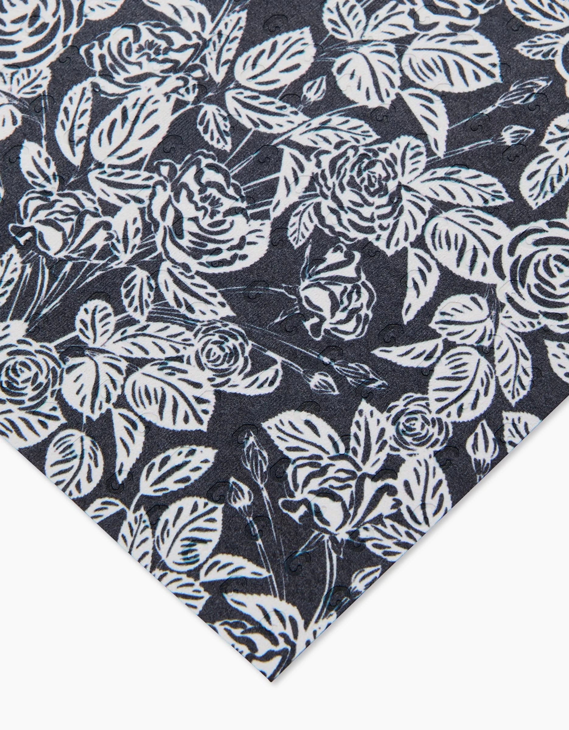 Love and Roses Onyx by Charlie Rowan Designs features a black background with white roses and leaves, shown from an angled corner view—an elegant design perfect for eco-friendly paper towels.