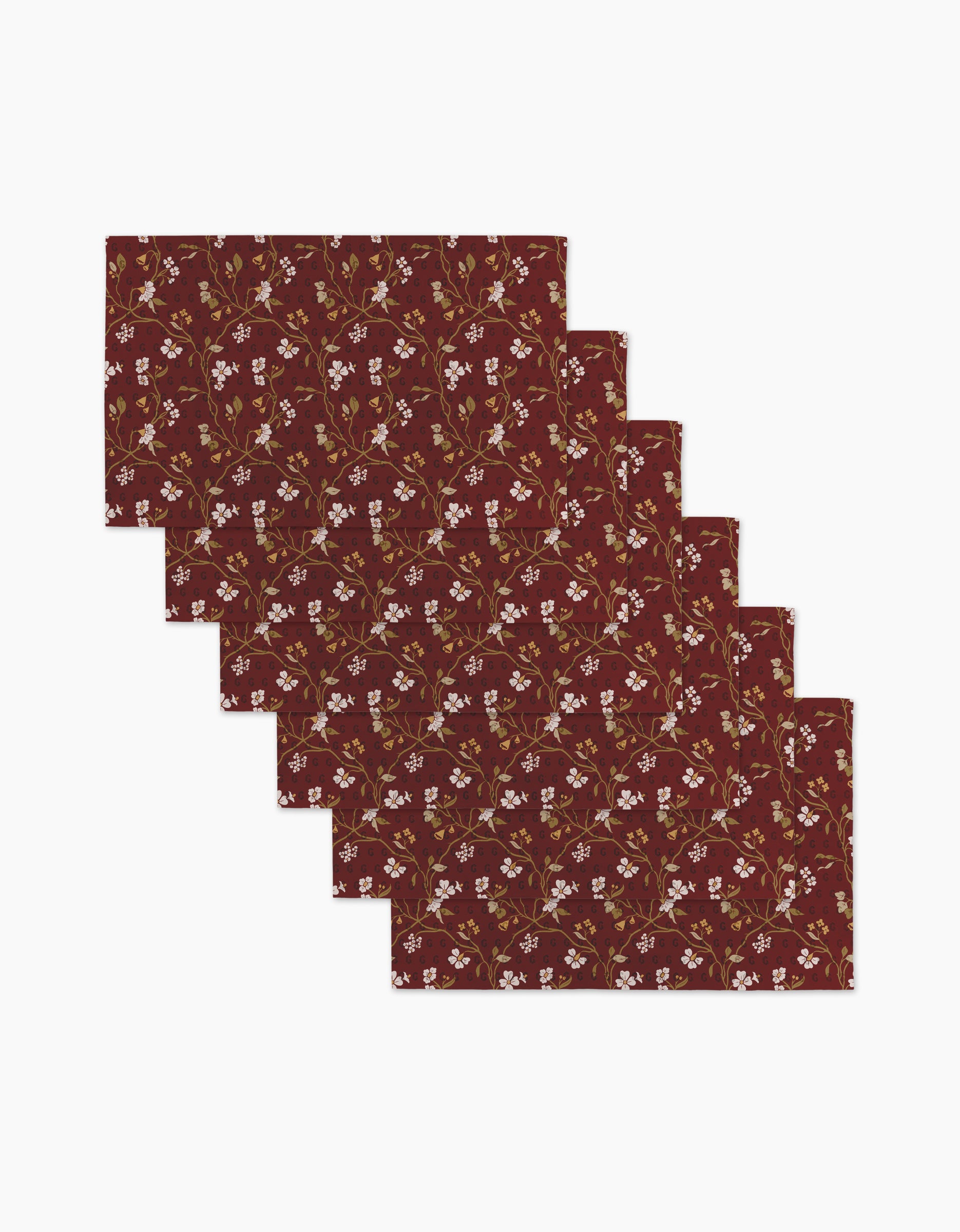 Six “Lunaria in Merlot” rectangular placemats by Danelys Sidron, featuring small white and yellow flowers with green leaves on burgundy—an elegant, reusable paper towel alternative for eco-conscious dining.