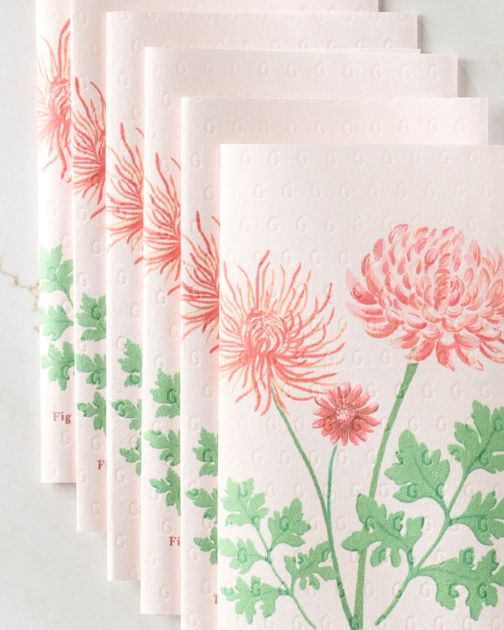 Five Linda Fox “November Chrysanthemum” eco-friendly kitchen towels with embossed G patterns are arranged in a fan shape. Each towel features a pink chrysanthemum and green leaf floral design and is reusable.