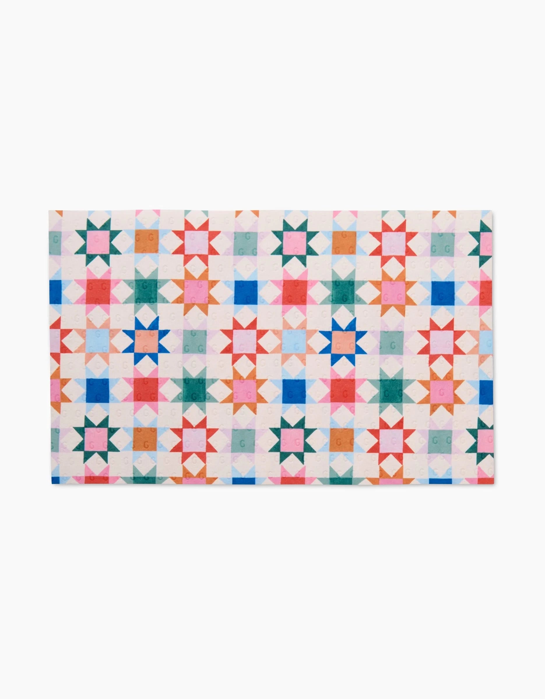 The Patchwork Picnic quilt by Brittany Jepsen features geometric stars in colorful grids on white, crafted from eco-friendly post-consumer recycled materials for sustainable style.