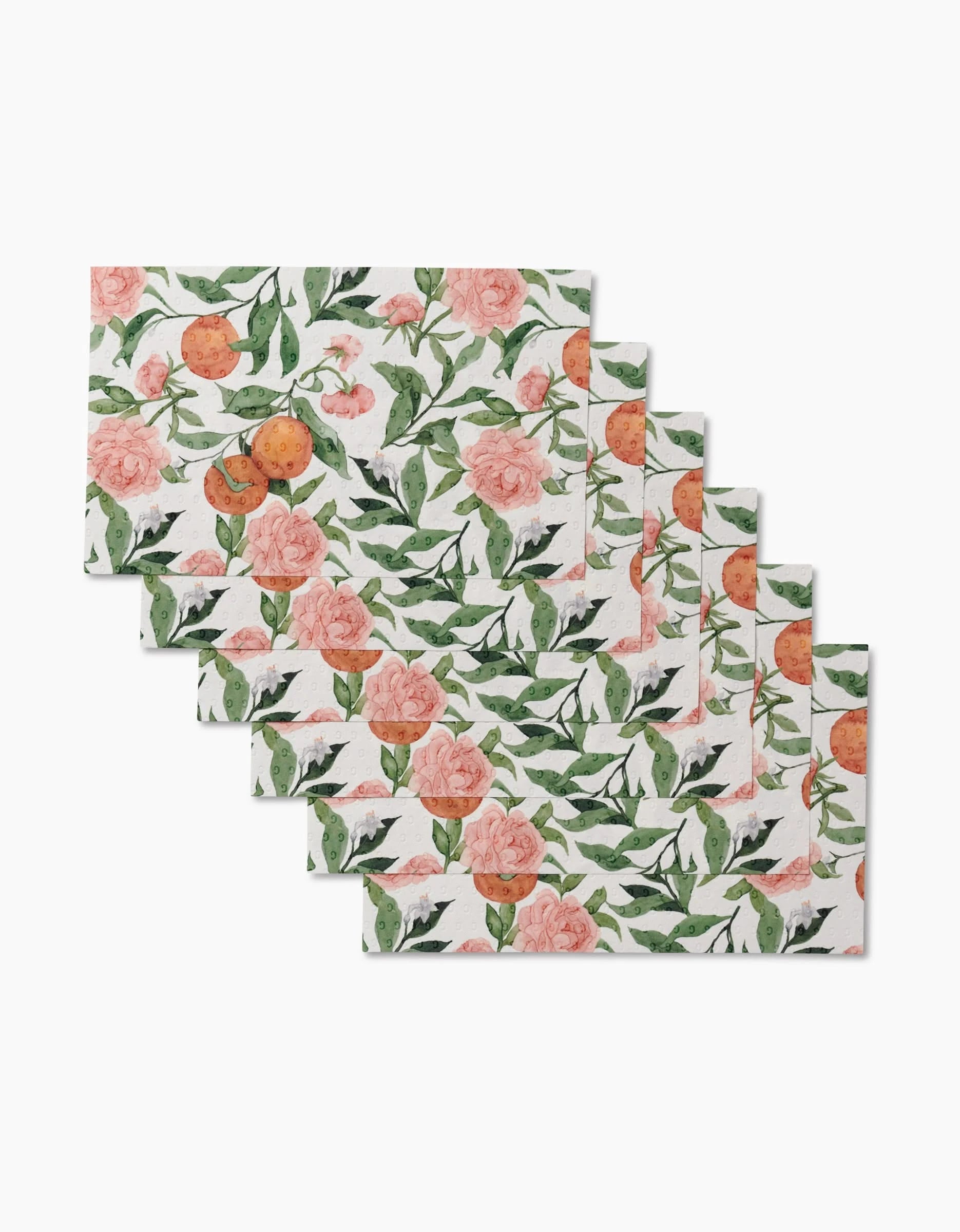 Eight Peony For Your Thoughts cloths by Aubrey Fairchild, stacked in a fan arrangement, feature pink roses, green leaves, and orange fruits on white—perfect as reusable, eco-friendly paper towels.