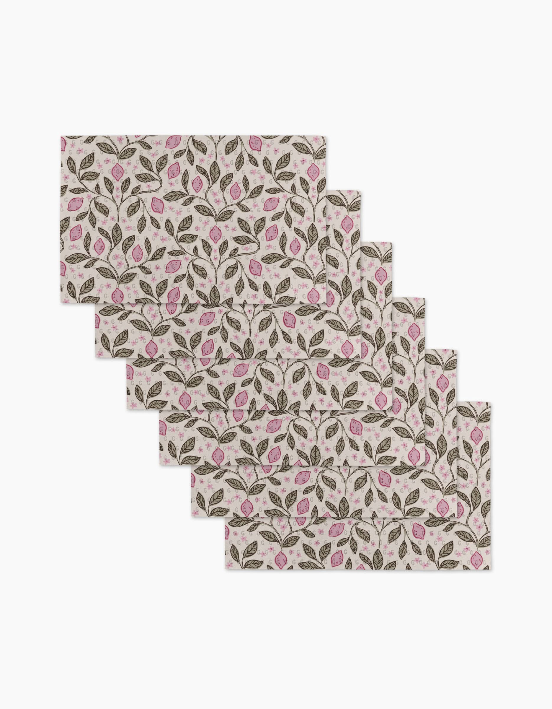Six rectangular placemats—Pink Summer Lemons by Teri the Butter—feature a repeating pattern of green leaves and pink flowers on a light background, made from eco-friendly kitchen towels for sustainable dining.