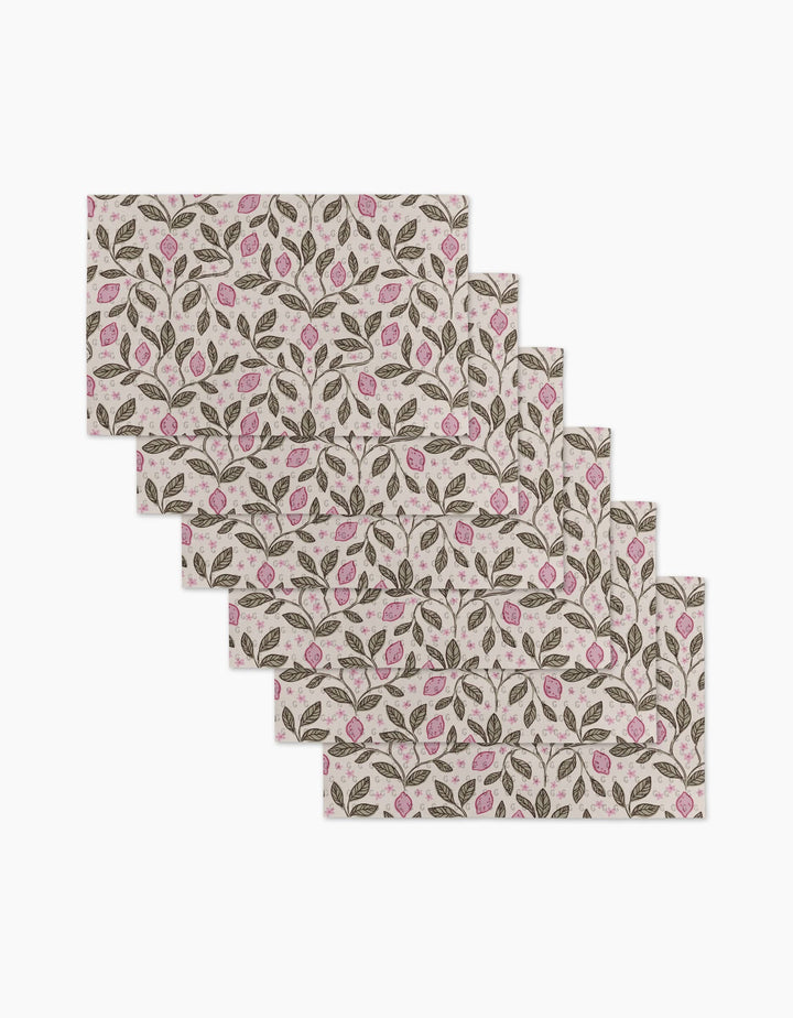 Six rectangular placemats—Pink Summer Lemons by Teri the Butter—feature a repeating pattern of green leaves and pink flowers on a light background, made from eco-friendly kitchen towels for sustainable dining.
