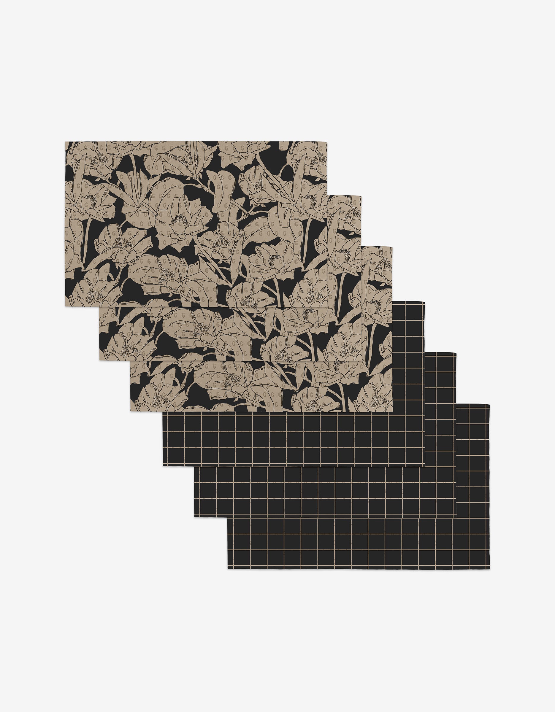 Six rectangular placemats—Aubrey Fairchild’s Plant One on Me—feature botanical leaf and grid patterns on black. Made from post-consumer recycled materials, they’re an eco-friendly alternative to Not Paper Towels.
