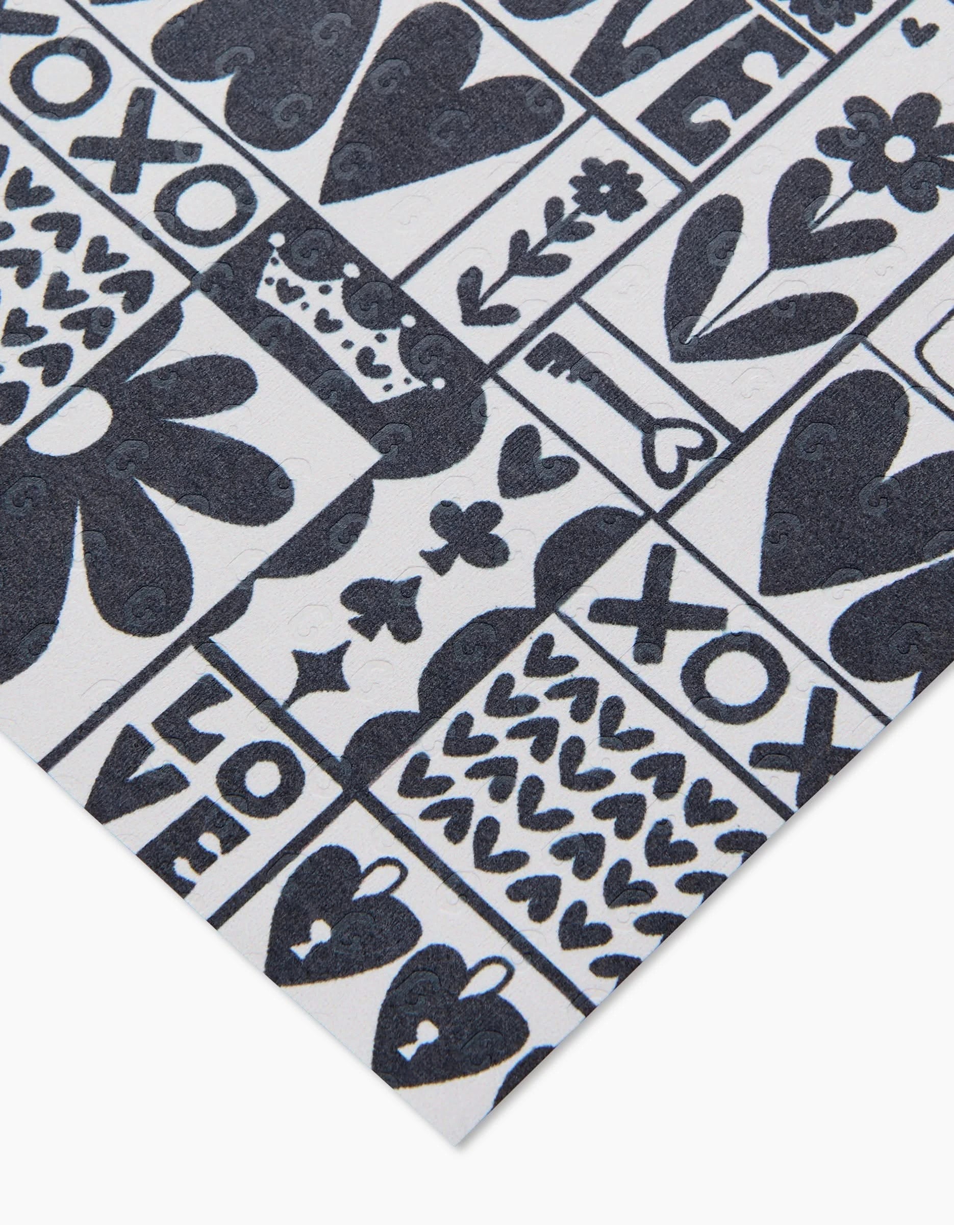 Queen of Hearts by Kayla Ann is a white sheet featuring black ink illustrations—hearts, flowers, XOXO, LOVE, and doodles—in a grid pattern. Made from post-consumer recycled materials for an eco-friendly choice.