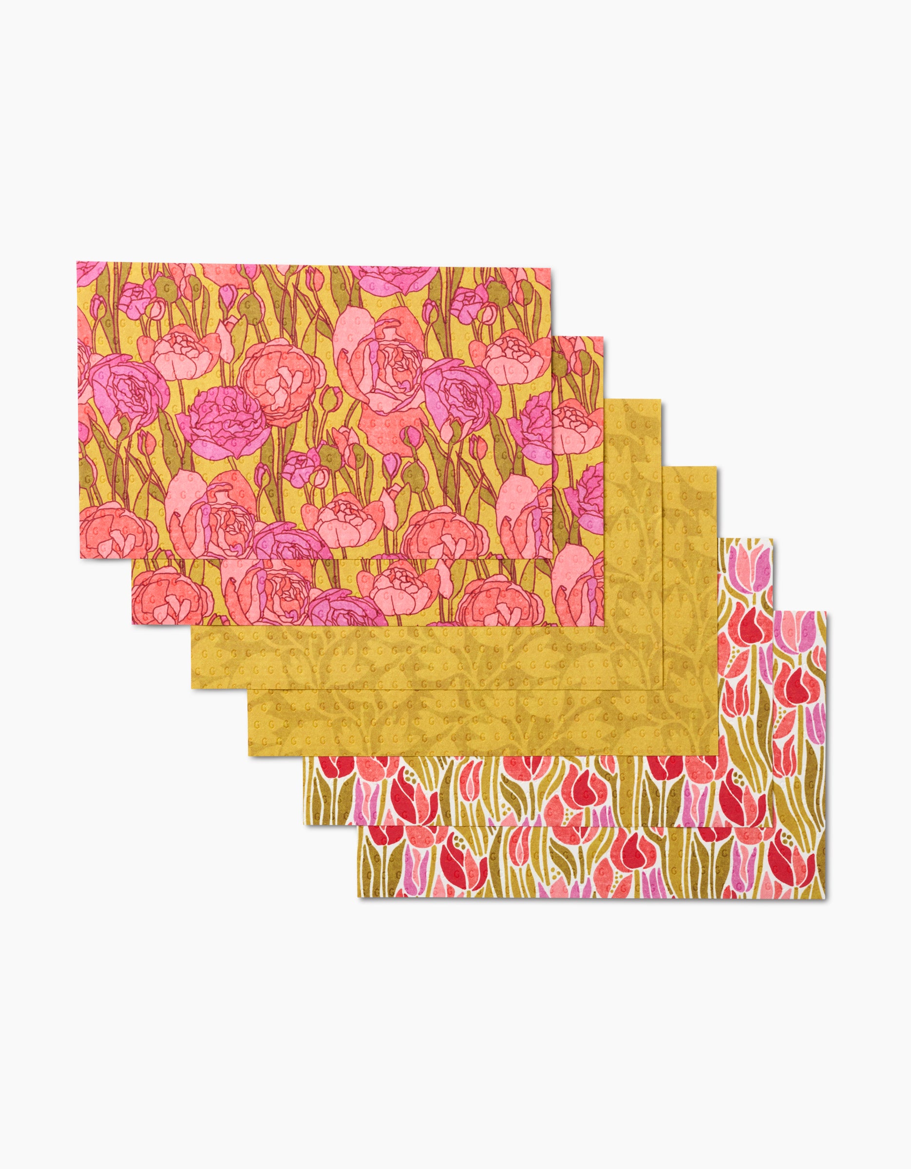 The Sidney set by Amy MacCready includes five rectangular, eco-friendly placemats, each with a unique floral pattern in pink, red, gold, and green—an attractive and sustainable alternative to paper towels.