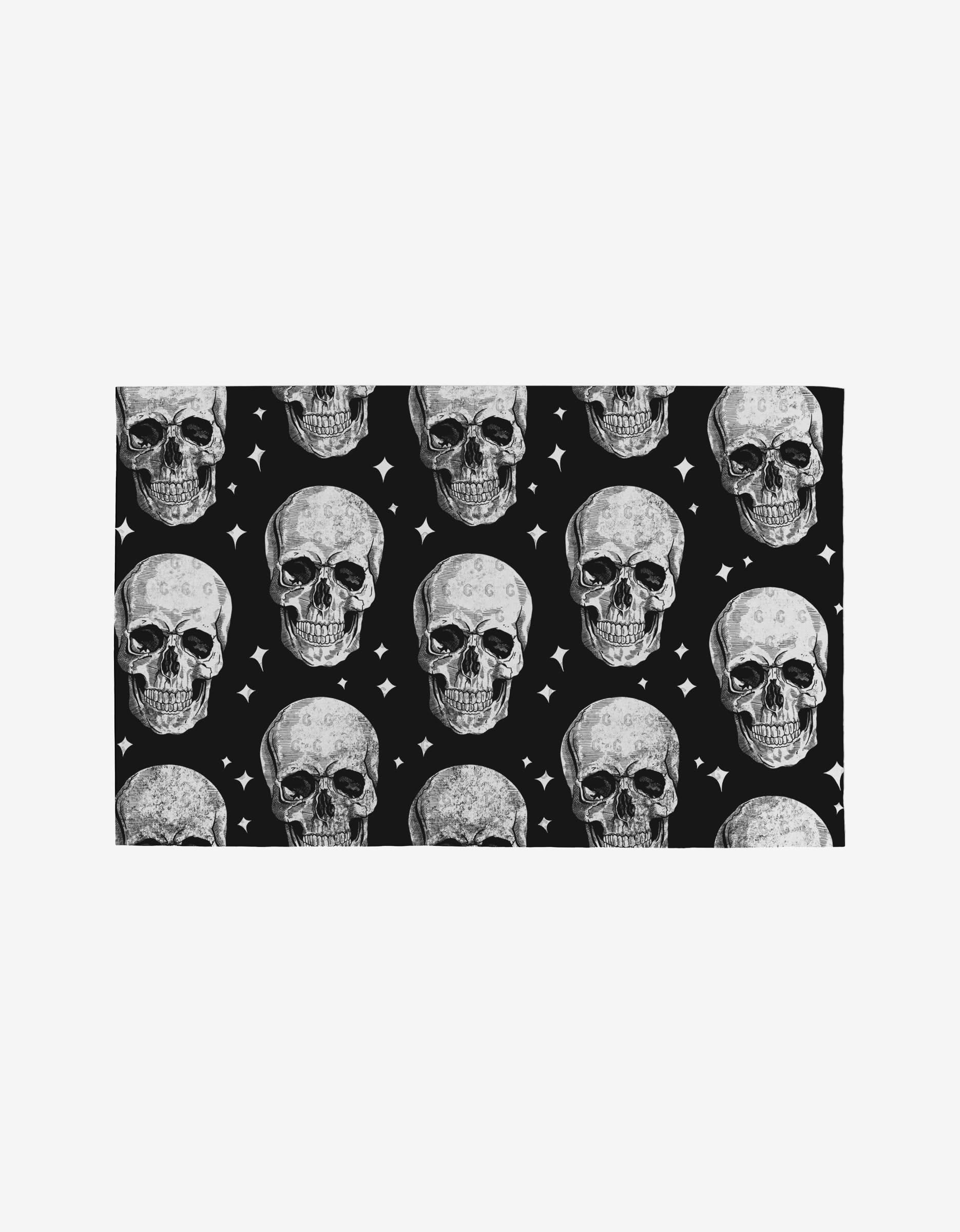 The GEOMETRY Skulls Not Paper Towels feature a repeating pattern of realistic human skulls and white stars on black, printed on towels made from post-consumer recycled materials.