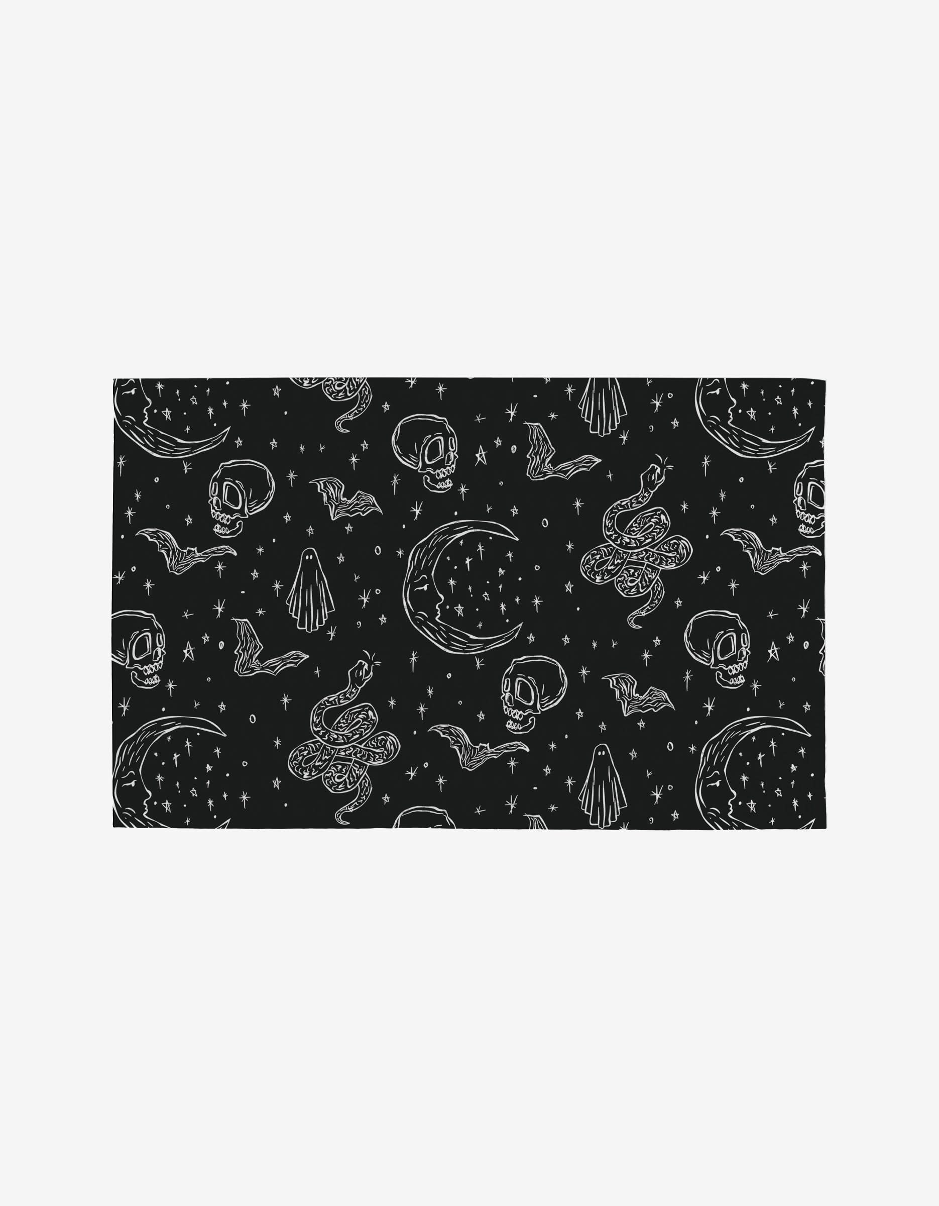 Skulls and Stars by Aubrey Fairchild: a black rectangular cloth with white skulls, stars, snakes, moons, and bats in a repeating pattern—an eco-friendly Not Paper Towels alternative made from post-consumer recycled materials.