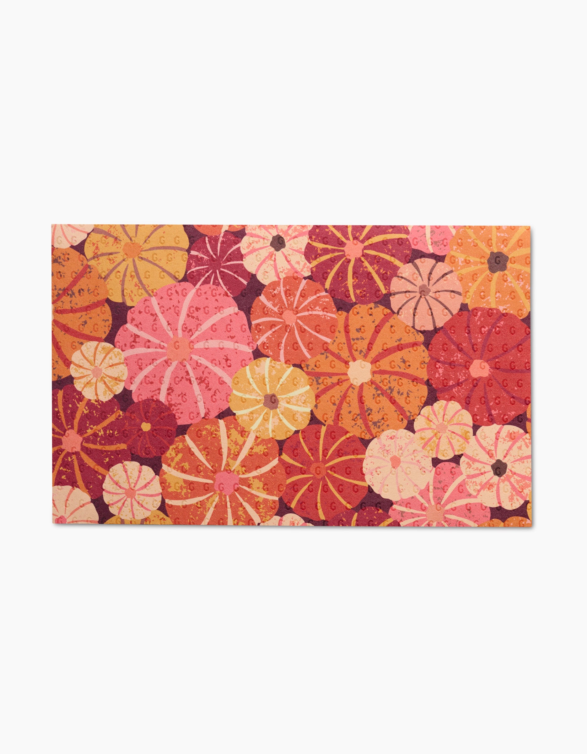 The Spicy Pumpkins mat by Rebecca Bobko showcases a vibrant floral pattern in pink, orange, red, and yellow on white. Use as eco-friendly kitchen towels or reusable paper towels for a cheerful touch—no more wasteful paper towels.
