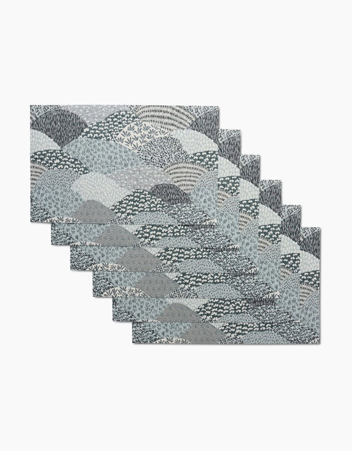 A set of six rectangular Sweet Valley Hills Green placemats by Hufton Studio, featuring a blue, gray, and white abstract wave and leaf pattern—an eco-friendly alternative to kitchen towels for stylish dining.