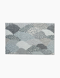 The Sweet Valley Hills Green rug by Hufton Studio features overlapping abstract hills in blue, grey, and white with small floral and leaf motifs—ideal for pairing with eco-friendly kitchen towels for a coordinated look.