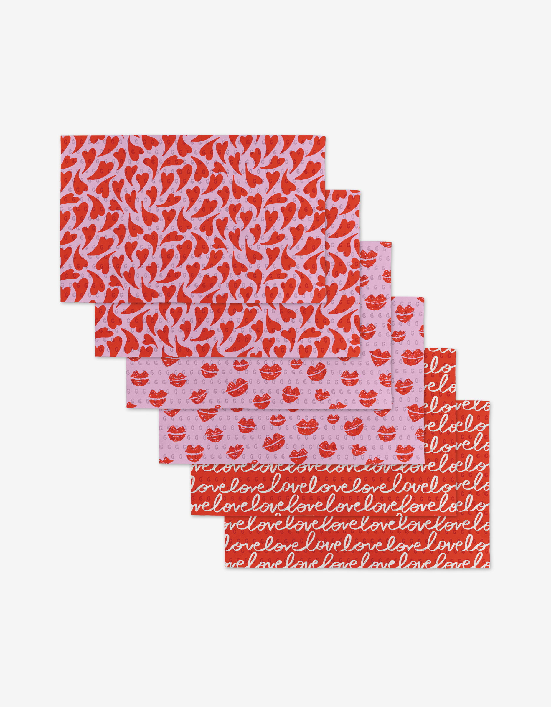 Kayla Ann’s Swooning Hearts includes five folded tissue sheets made from post-consumer recycled material, with red and pink Valentine designs—hearts, lips, and “love” script—arranged fan-style.