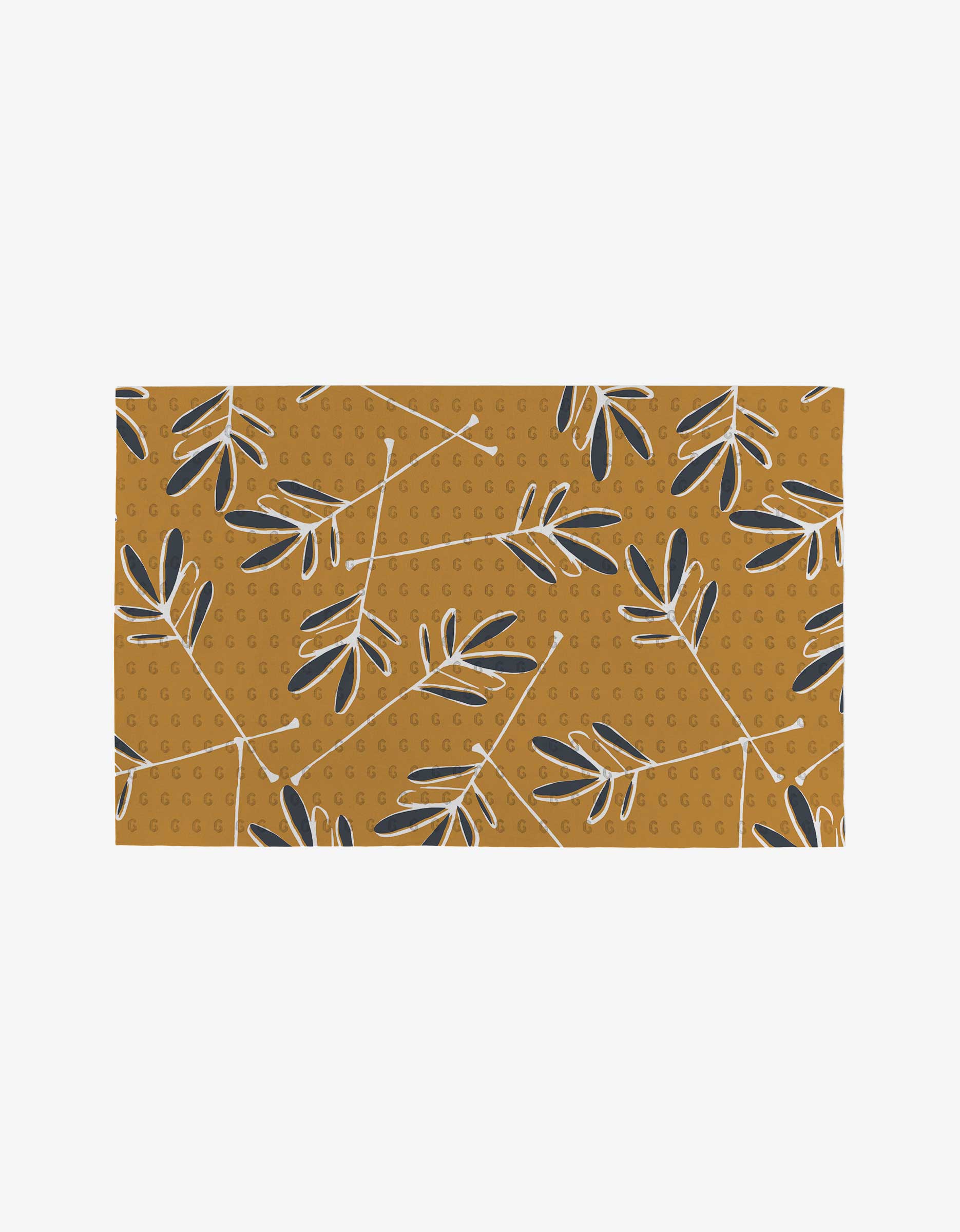 The Tess rug by GEOMETRY is a rectangular mustard yellow piece featuring black and white leaf motifs, thin white branches, and dotted circles. Made from post-consumer recycled materials.