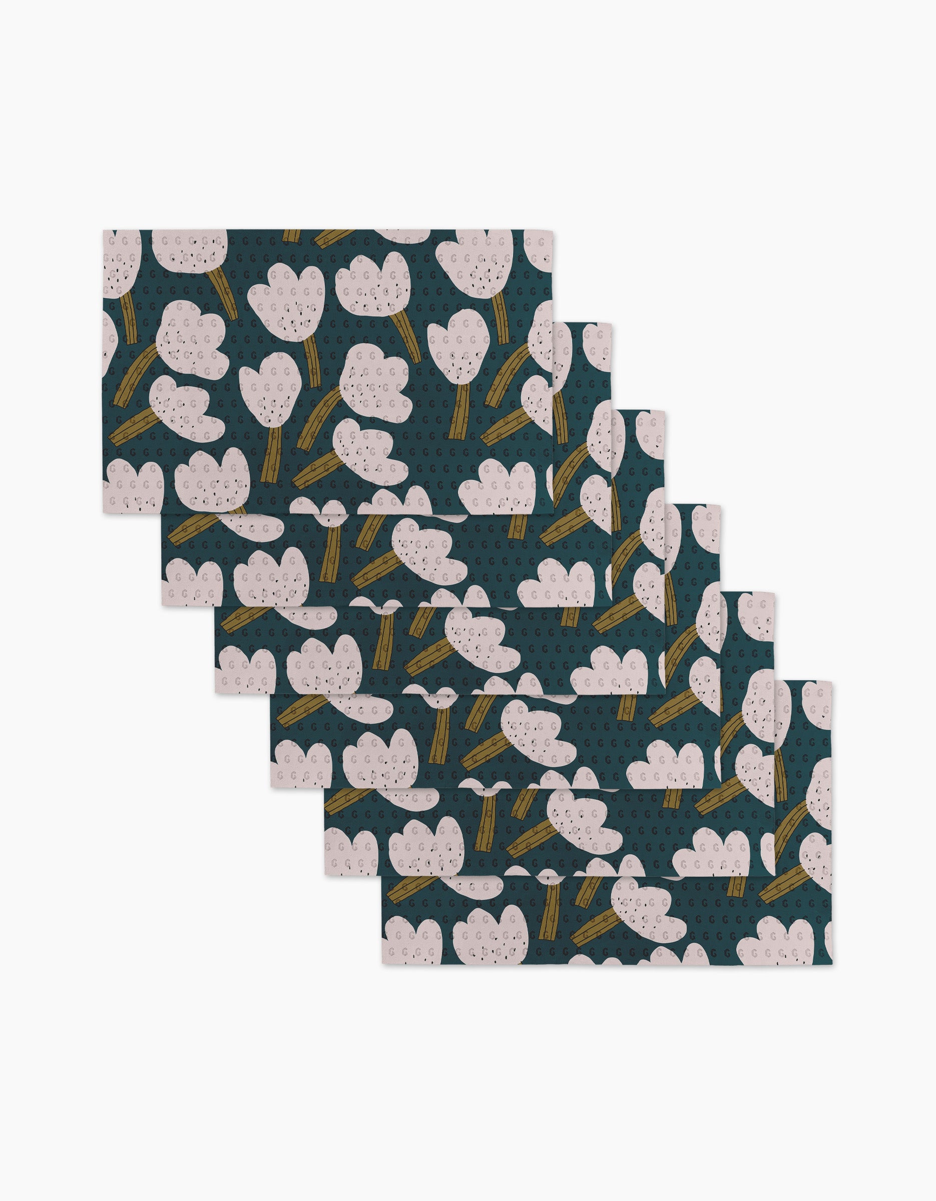A set of six "Tulips" rectangular placemats by Jennifer Bouron, featuring a pink and white tree design with yellow trunks on dark green—eco-friendly and perfect for pairing with recycled paper towels. Arranged in a fan shape.