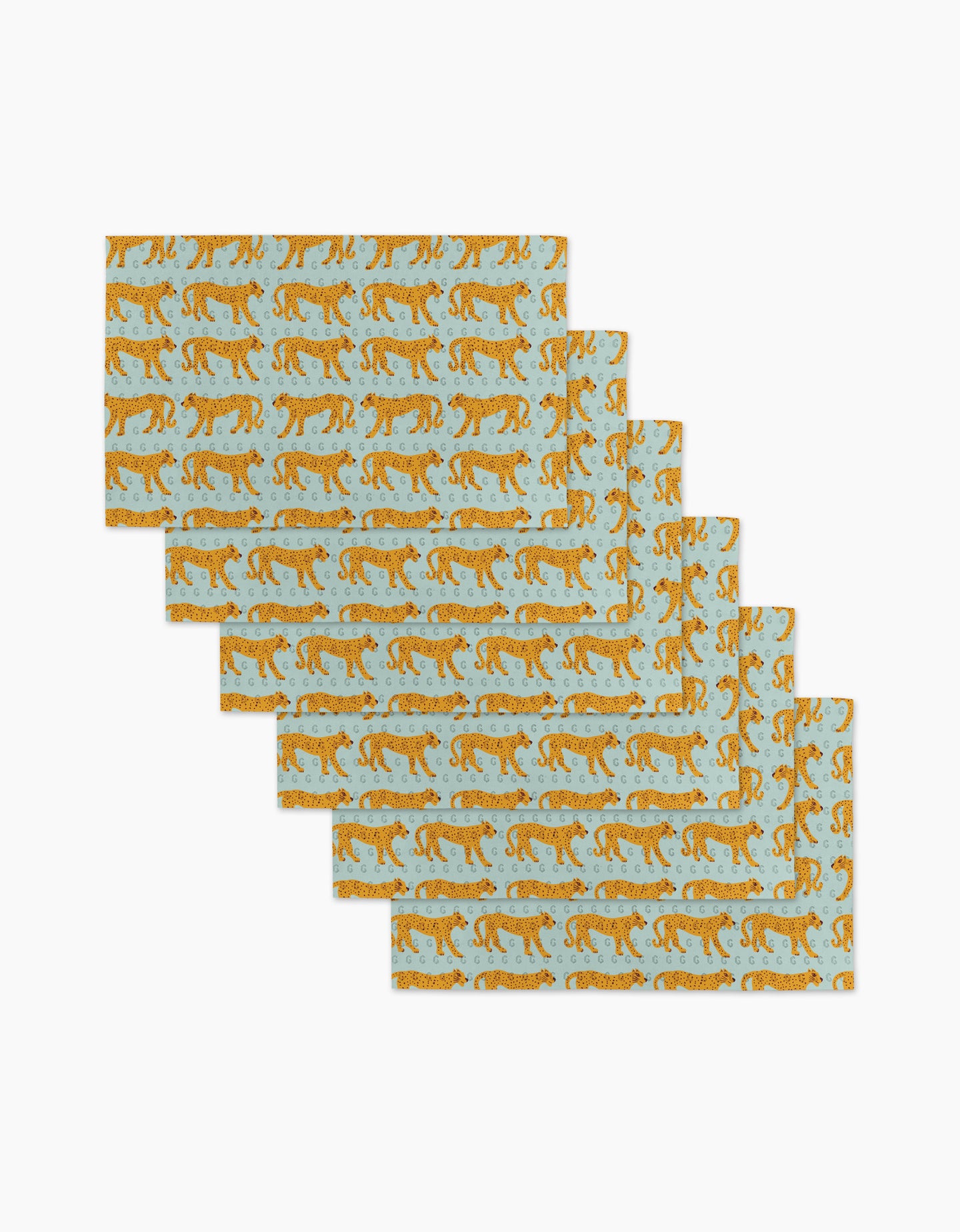 Six Walking Cheetah rectangular placemats by Jasmine Blooms Designs, featuring orange cheetahs on light blue, made from post-consumer recycled materials, are displayed in a fanned-out stack on a white surface.
