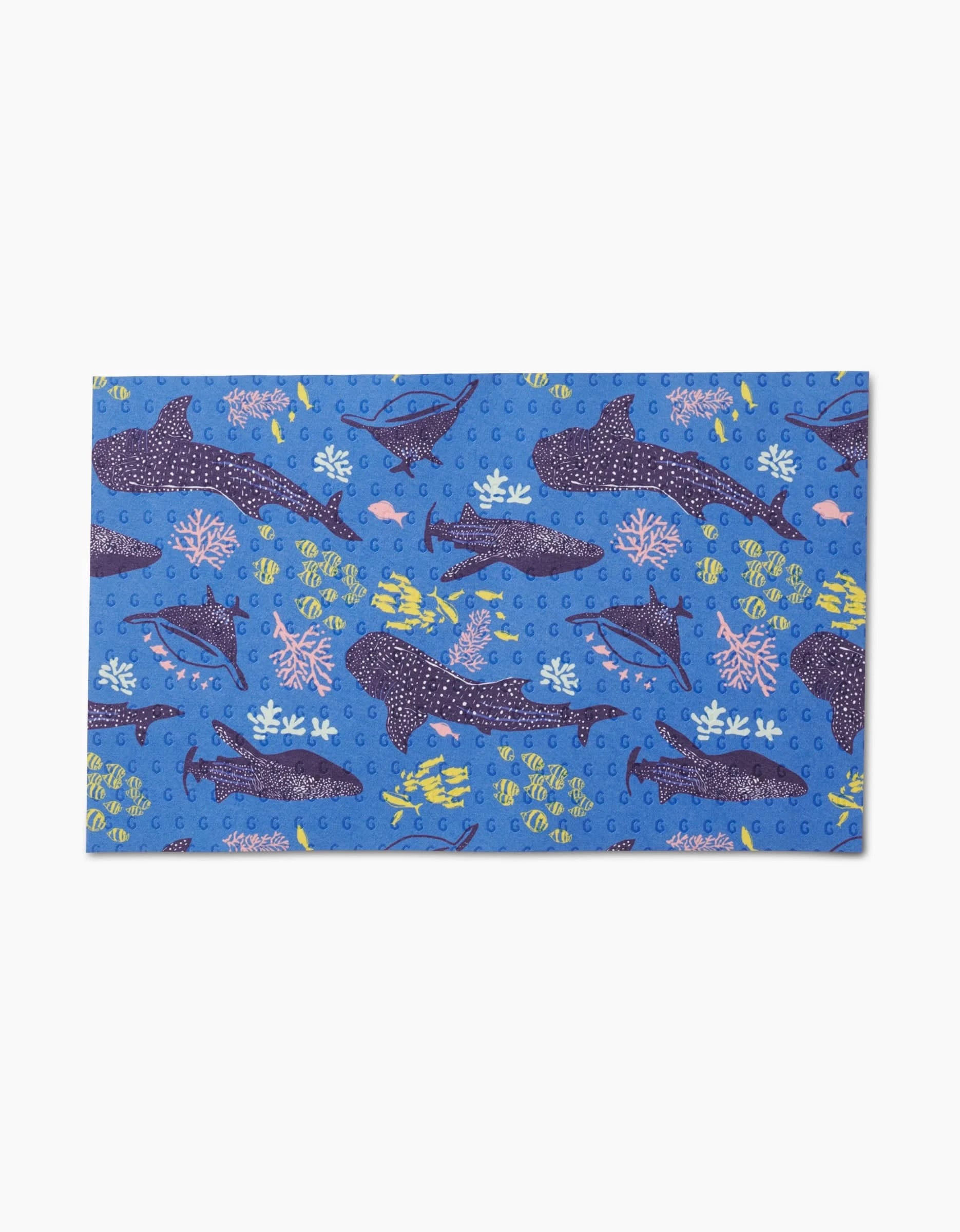 The Elisabeth Wing Whale Shark mat features cartoon whales, dolphins, fish, and coral on a light blue background—an eco-friendly, reusable alternative to Not Paper Towels.
