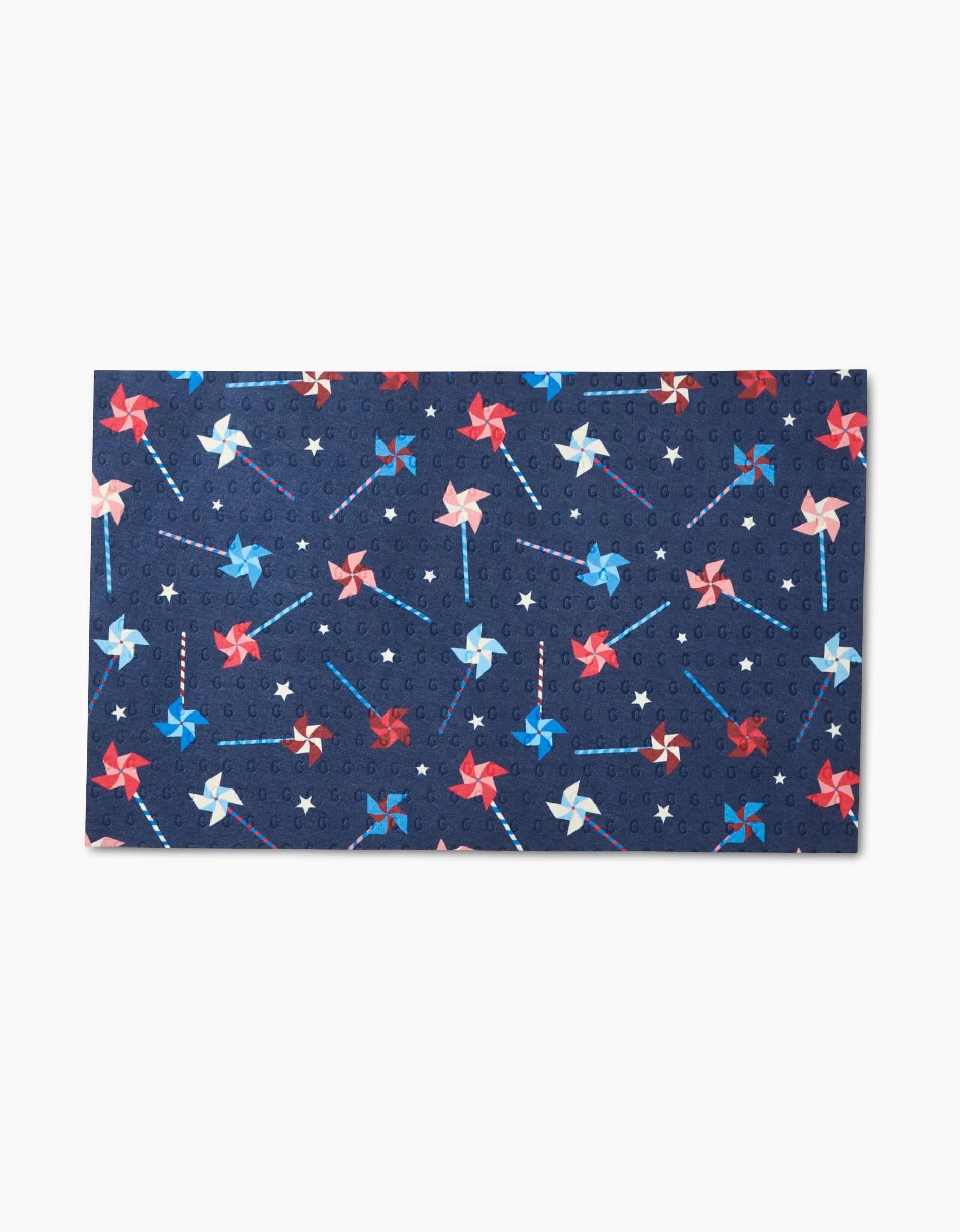 Whirlwind Pins by Rebecca Bobko is a rectangular, reusable mat with a dark blue background, red, white, and blue pinwheels, and small stars—an eco-friendly alternative to Not Paper Towels.