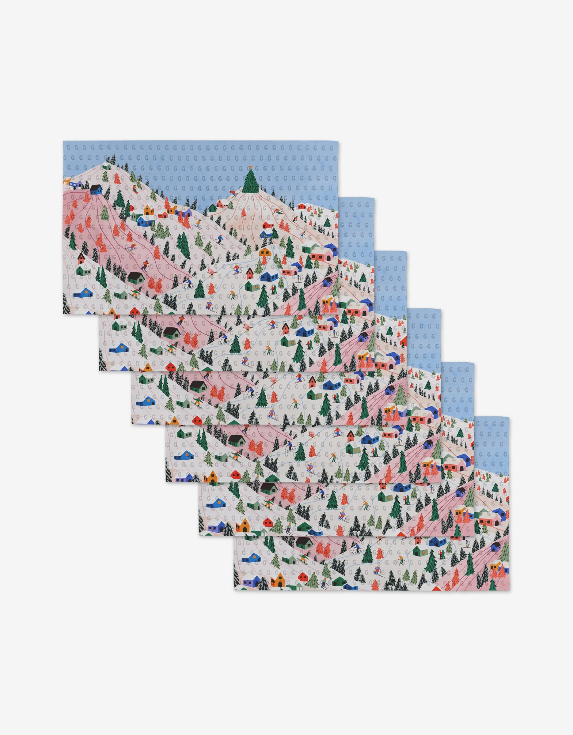 Six identical Winter Holiday placemats by Ceyda Alasar, showing skiers, trees, chairlifts, and snowy mountains under a blue sky—an eco-friendly alternative to Not Paper Towels. Arranged in a staggered stack on a white background.