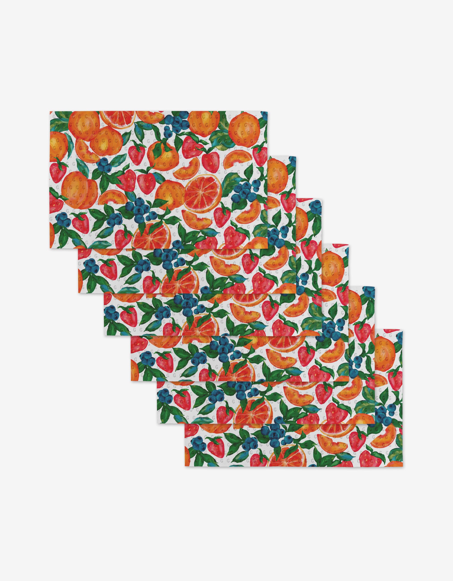 Zesty Life by Aubrey Fairchild: a set of six reusable rectangular placemats with a vibrant fruit and leaf pattern on white. Eco-friendly, not paper towels, these placemats are stacked in a stylish, staggered arrangement.