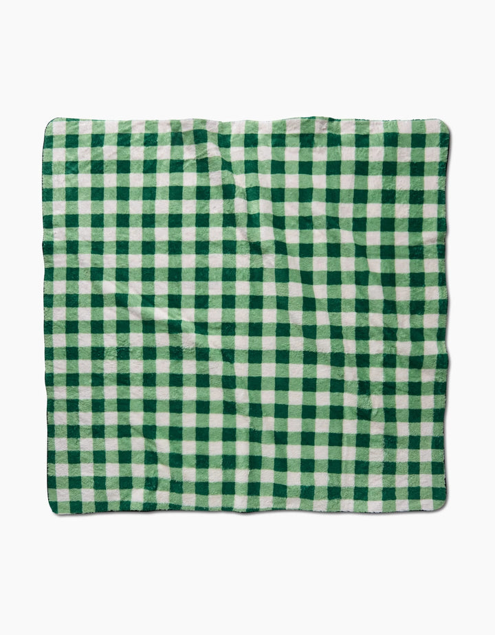 The Danelys Sidron Grass Plaid, a rectangular blanket with a green and white checkered pattern made from recycled materials, is displayed flat against a white background.