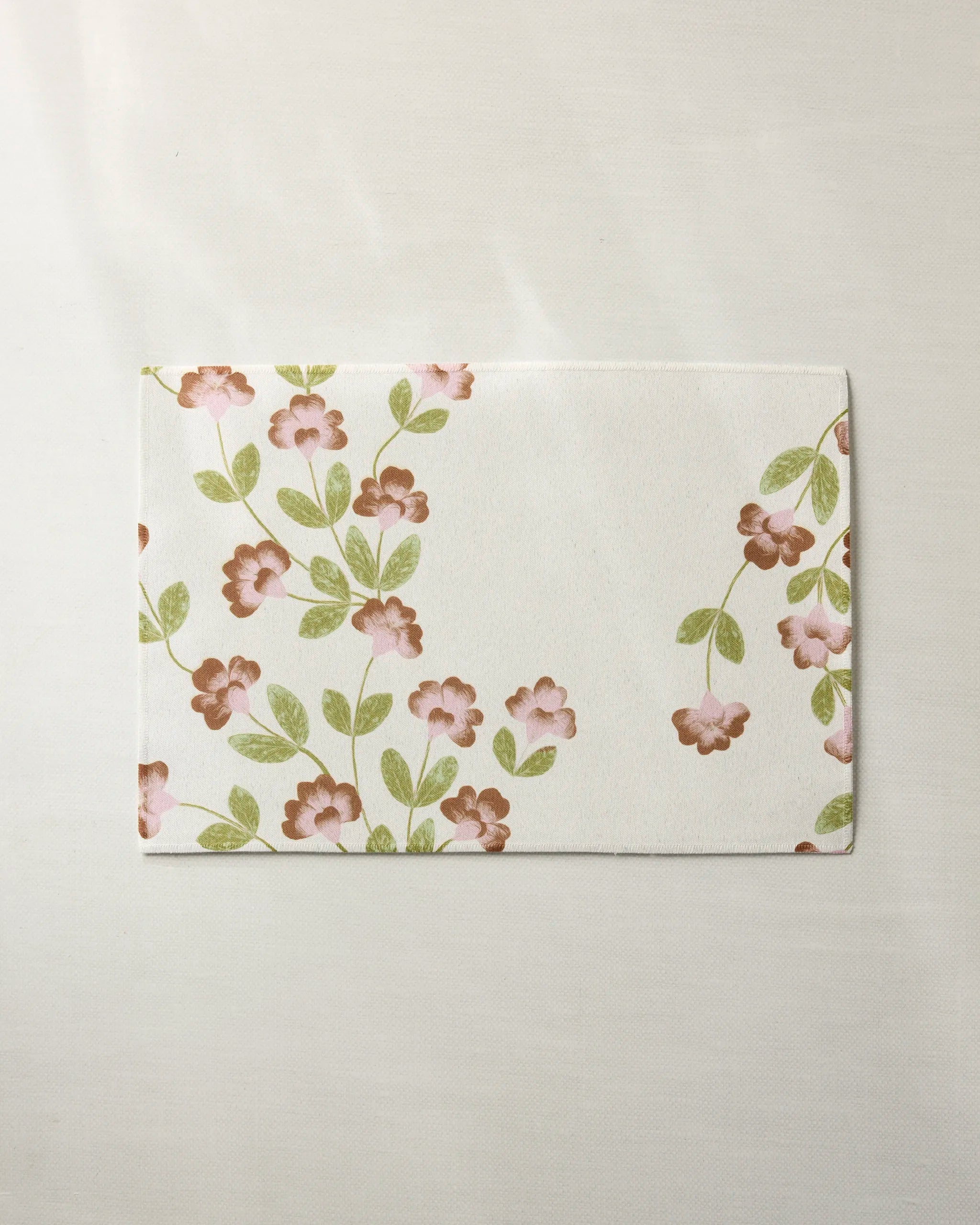 The Geometry Flower Tower napkin features a pink and green floral design on white, making it a stylish, eco-friendly choice for your table and pairing perfectly with sustainable or machine-washable tableware.