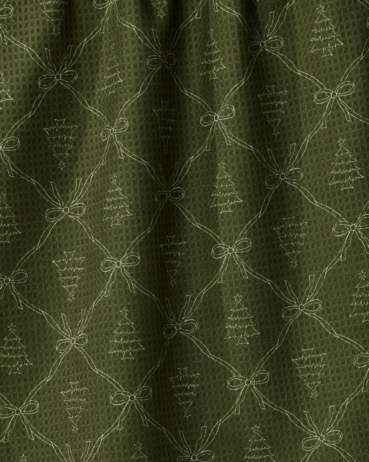 Introducing Cedar Bows by Geometry—a festive green tea towel featuring a stitched pattern of bows and Christmas trees arranged in a diamond grid. The subtle waffle texture ensures this quick-drying towel is as practical as it is cheerful, while the light green stitching enhances its understated holiday charm.