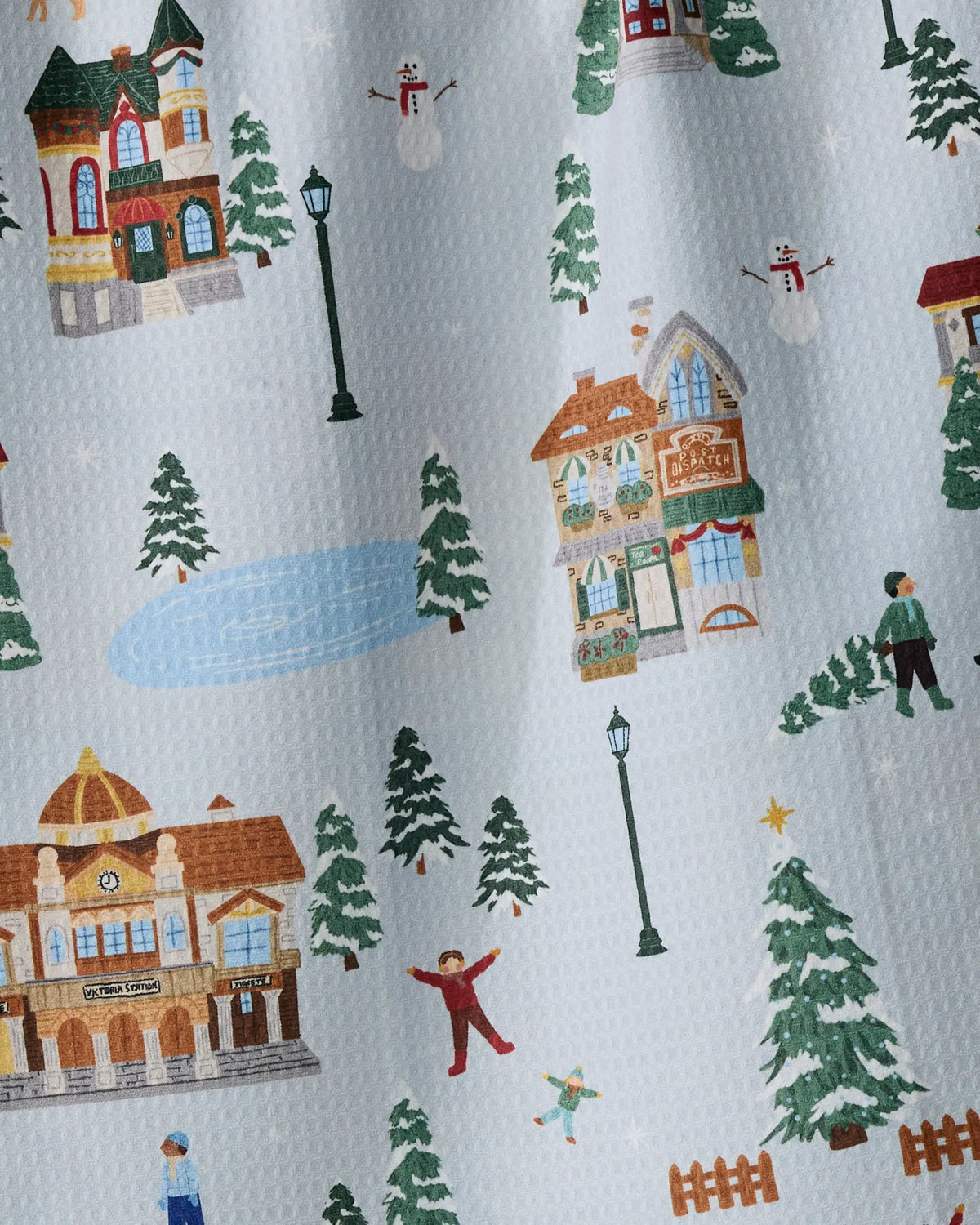 Experience the cozy charm of Geometry’s “Holiday Nostalgia” with an illustrated winter village scene. This design features buildings, pine trees, lamp posts, snowmen, an ice skating rink, and people enjoying winter activities—all set on a textured backdrop inspired by a recycled kitchen towel.