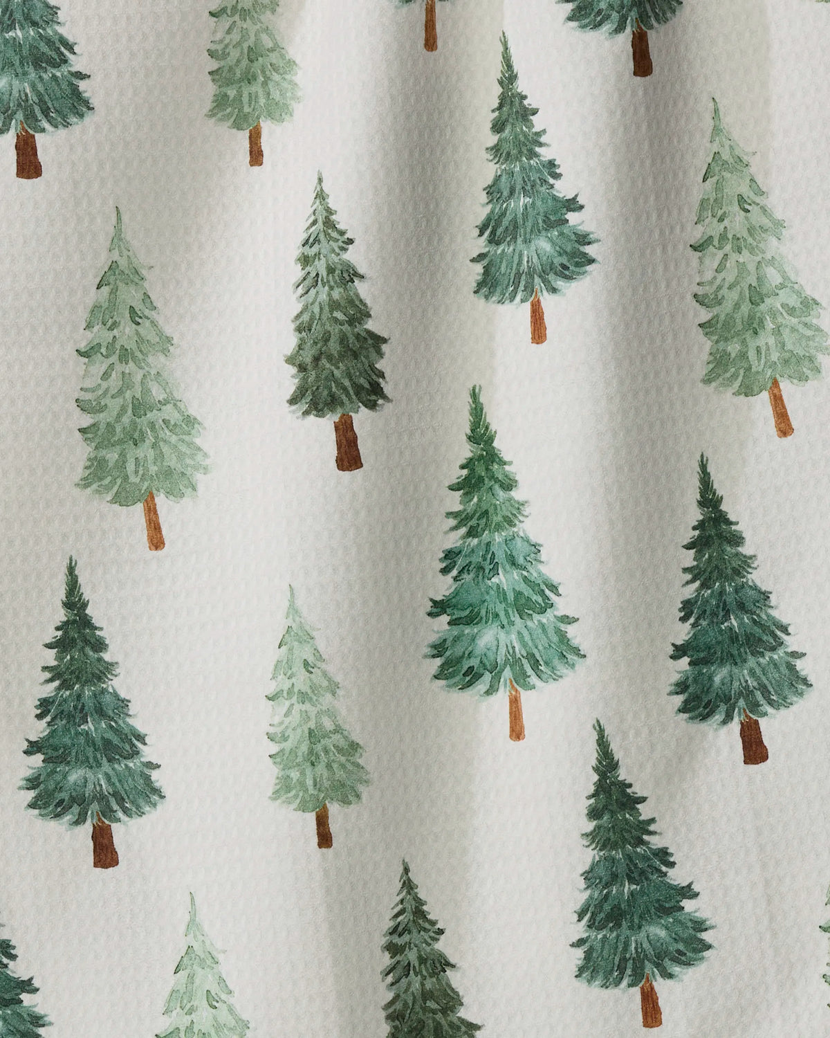 Pine Grove by Geometry features a pattern of green watercolor-style pine trees with brown trunks on a textured white background, arranged in rows—making it the ideal recycled kitchen towel that balances eco-friendly design with visual appeal.