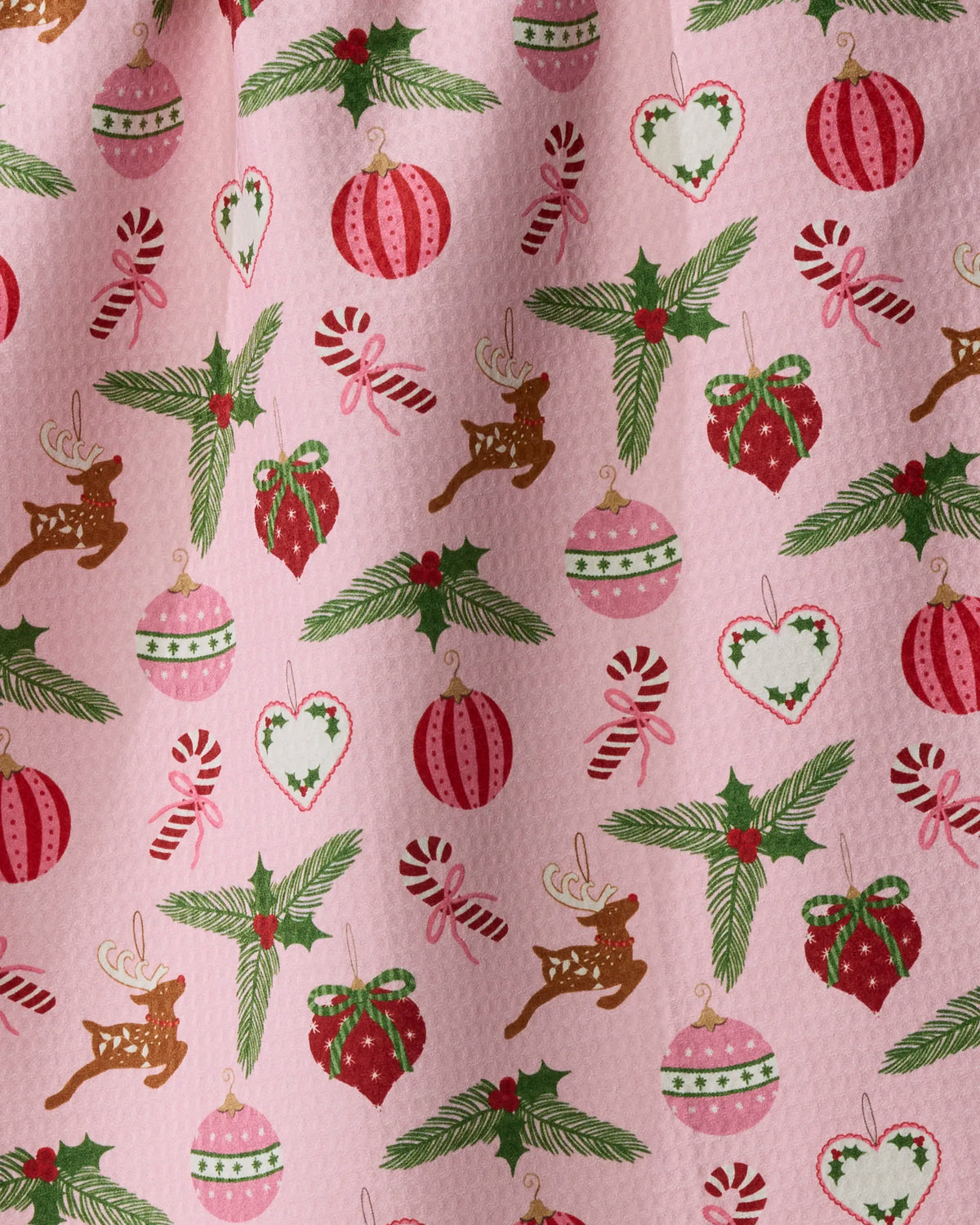 Introducing “Pink Tidings” by Geometry—a double-sided tea towel made from recycled materials, designed to be quick-drying and eco-friendly. Featuring a pink background with a festive Christmas pattern of red, green, and white reindeer, ornaments, holly sprigs, candy canes, and heart-shaped decorations, this tea towel is perfect for bringing holiday cheer to your kitchen.